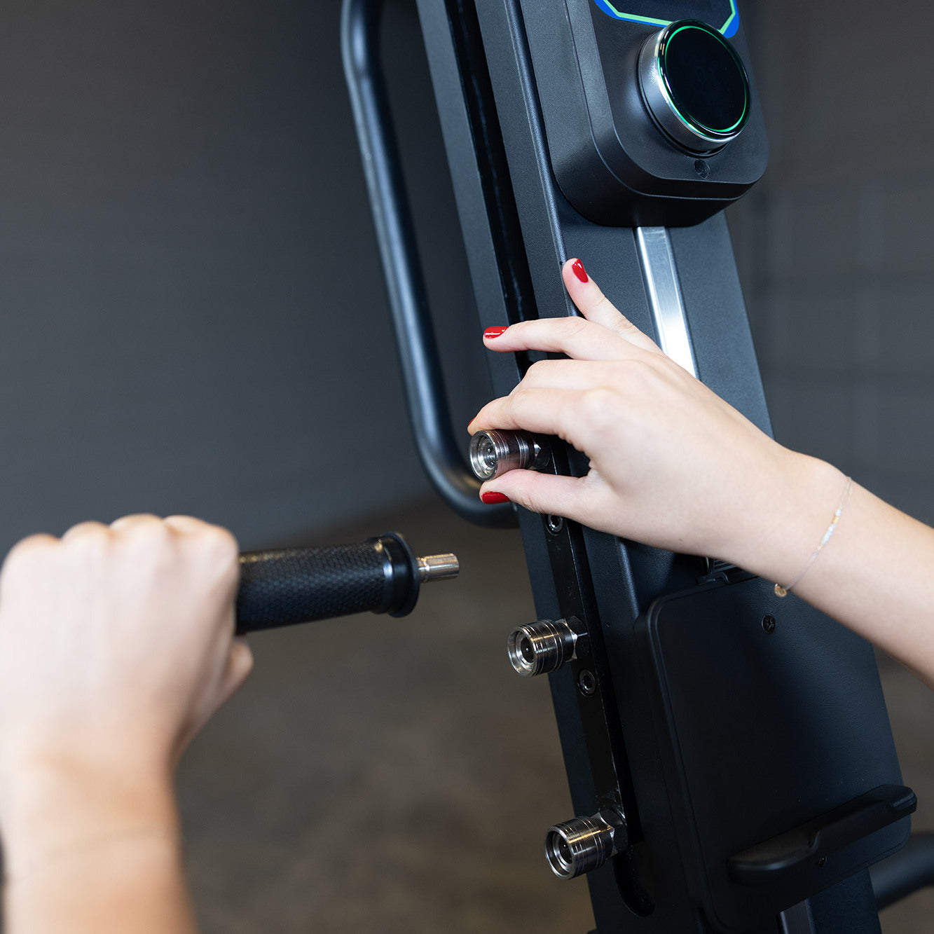 Close-up of adjusting handle position on Body-Solid Endurance CL300 vertical climber showing multiple grip settings