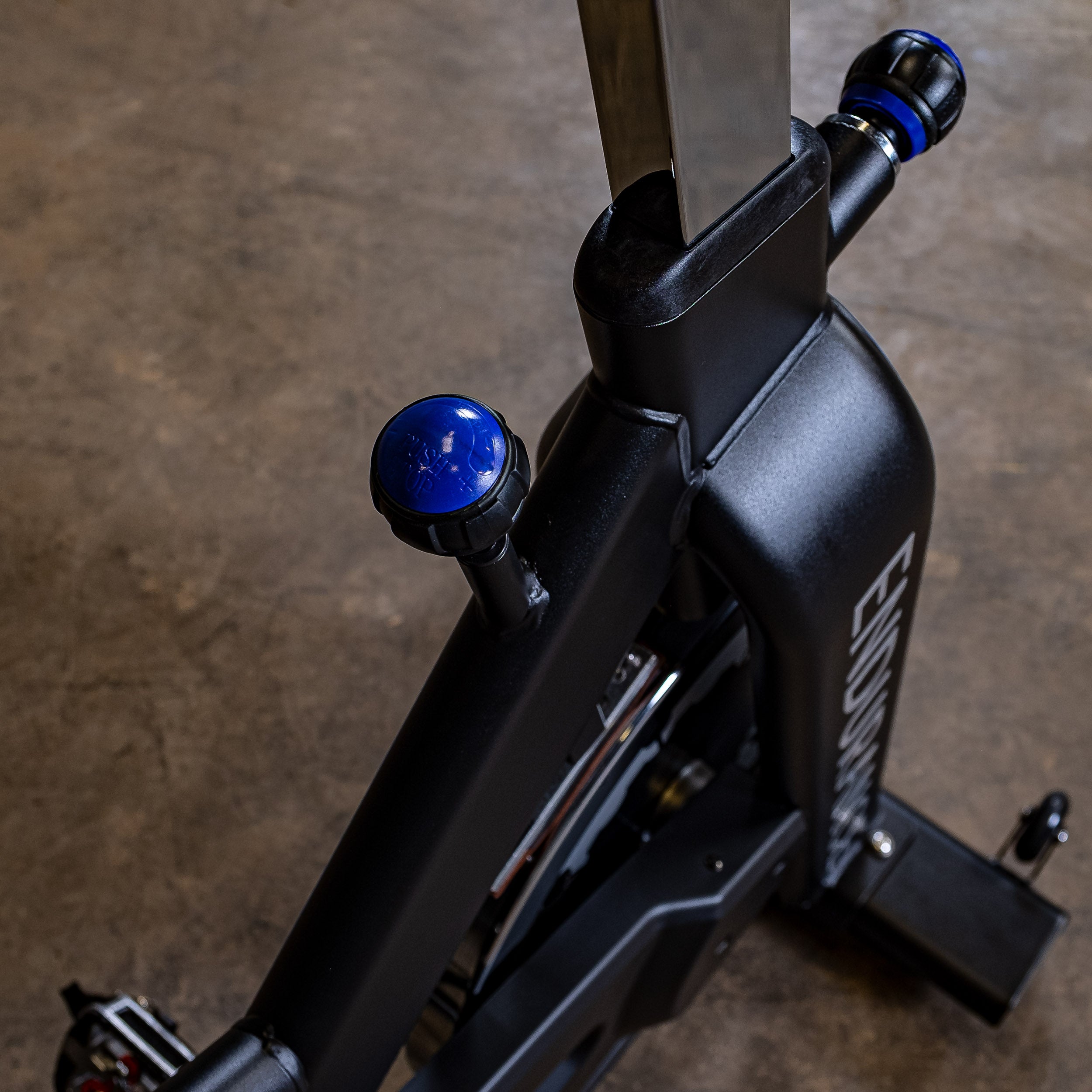 Close-up of the Body-Solid Endurance ESB250 indoor training cycle friction resistance adjustment knob and commercial-grade frame