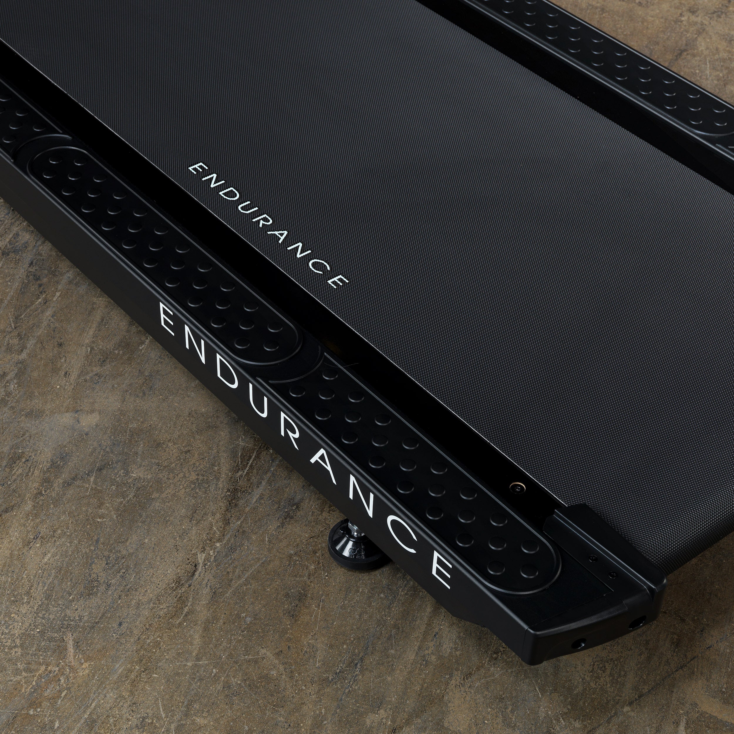 Close-up of Body-Solid Endurance T150 treadmill running deck and side rails with Endurance branding