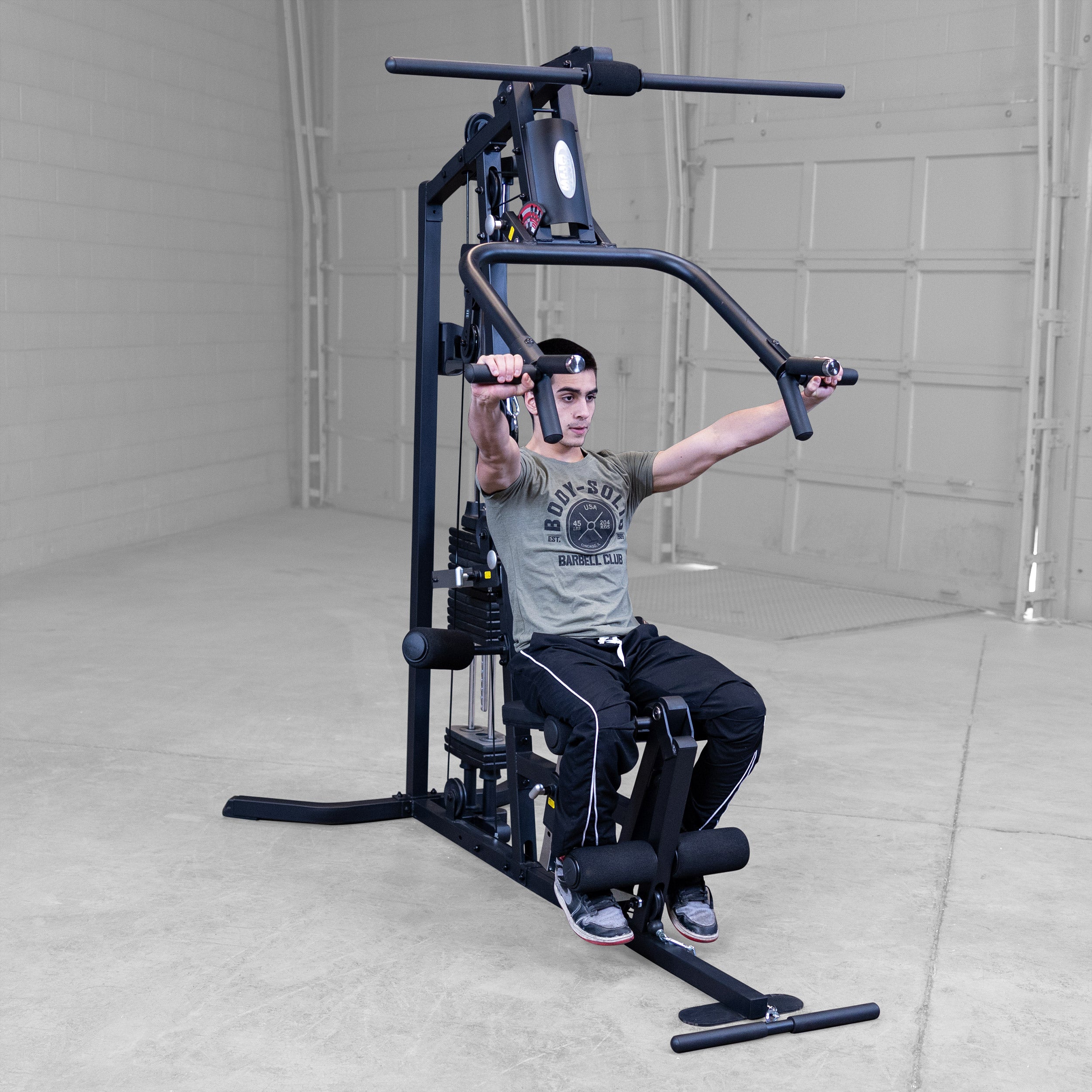 Person performing chest presses on the Body-Solid G3B multi station home gym to strengthen the chest shoulders and triceps