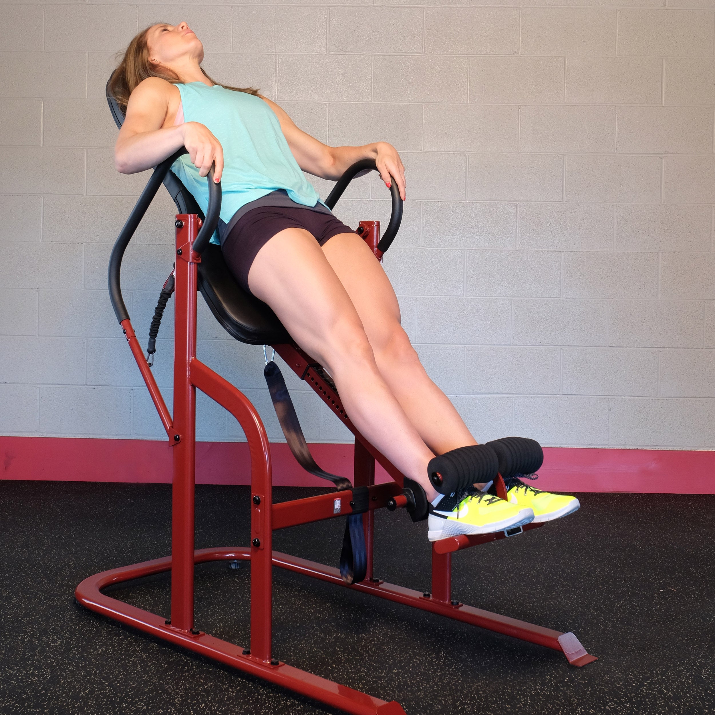 Woman using the Body-Solid GINV50 Inversion Table for controlled inversion and stretching