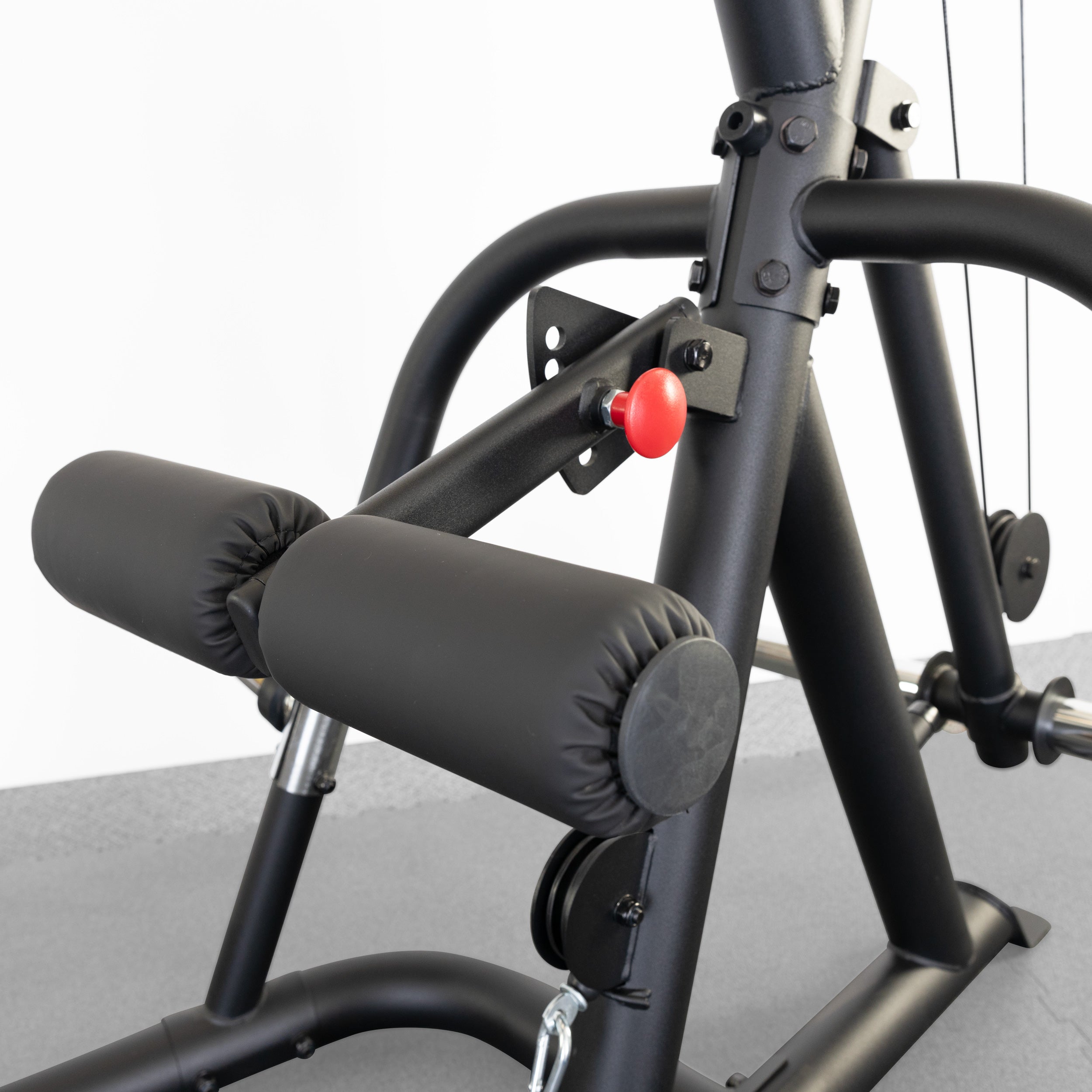 Close-up of the Body-Solid GLGS100B Corner Leverage Gym adjustable leg hold-down system