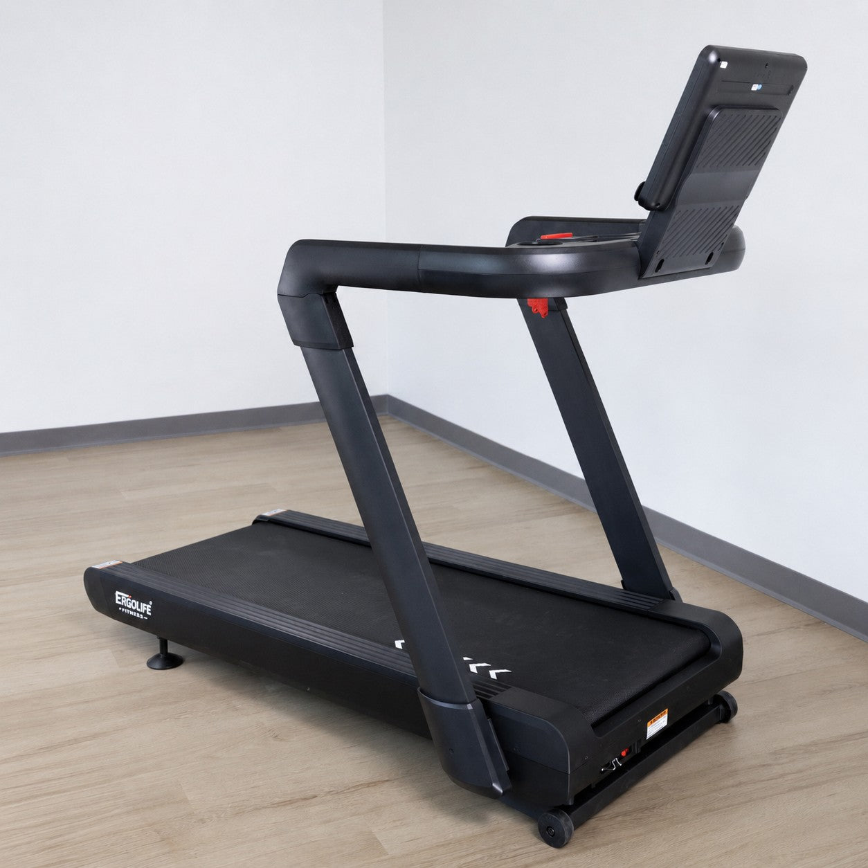 Side view of the ERGOLIFE 102 adjustable incline treadmill with built-in display, tablet holder, and spacious running deck