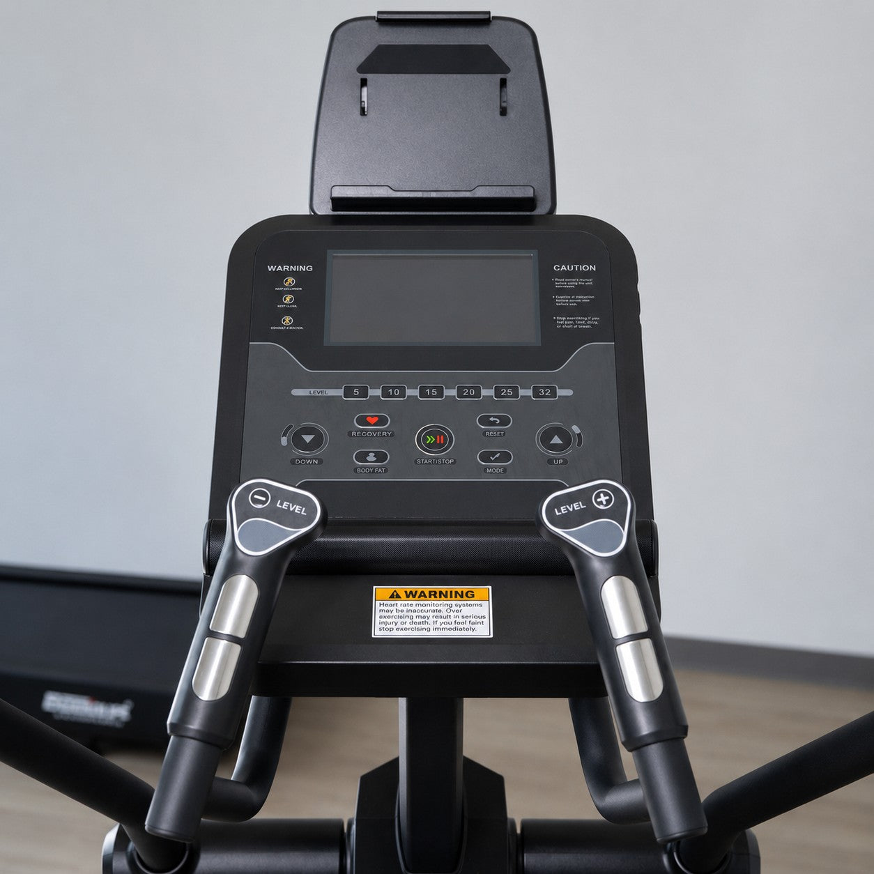 Close-up of the LCD console and heart rate handlebars on the ERGOLIFE CT51 elliptical with integrated tablet holder and performance controls