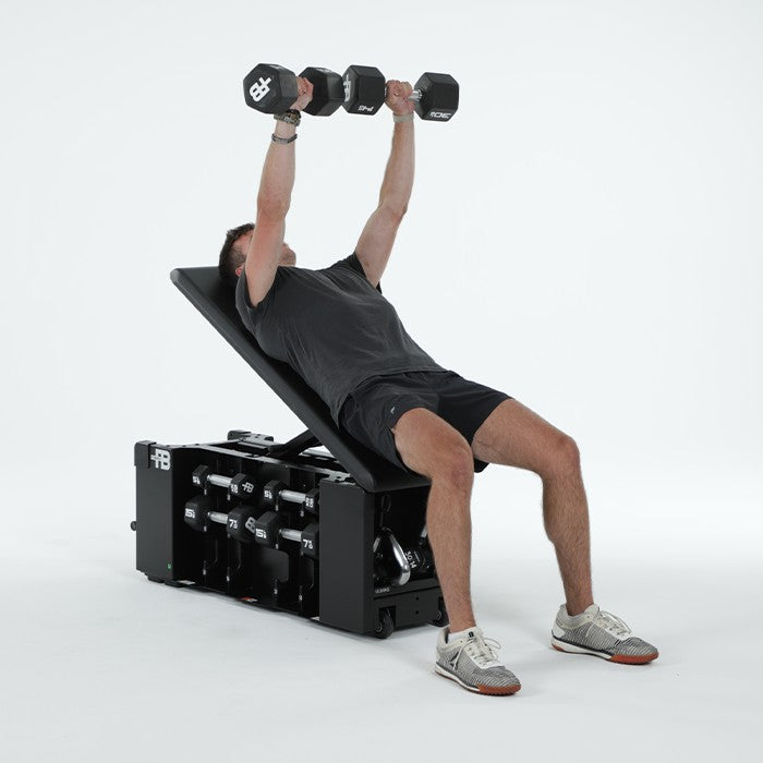 Man performing incline dumbbell press on FITBENCH One NXT Gen workout bench