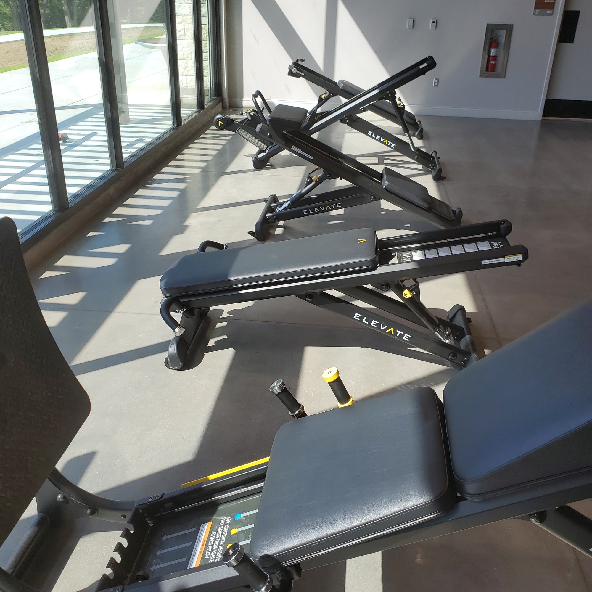 Total Gym ELEVATE Circuit 5-station commercial bodyweight training system displayed in a fitness facility showing the included training stations