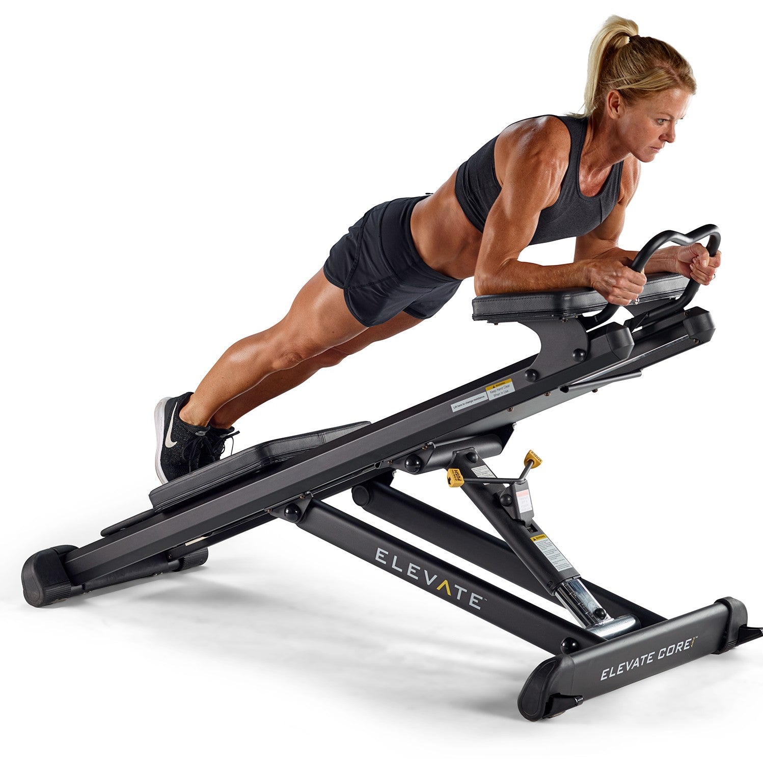 Person performing a dynamic plank exercise on the Total Gym ELEVATE Core ADJ Adjustable Core Trainer to build core strength stability and balance