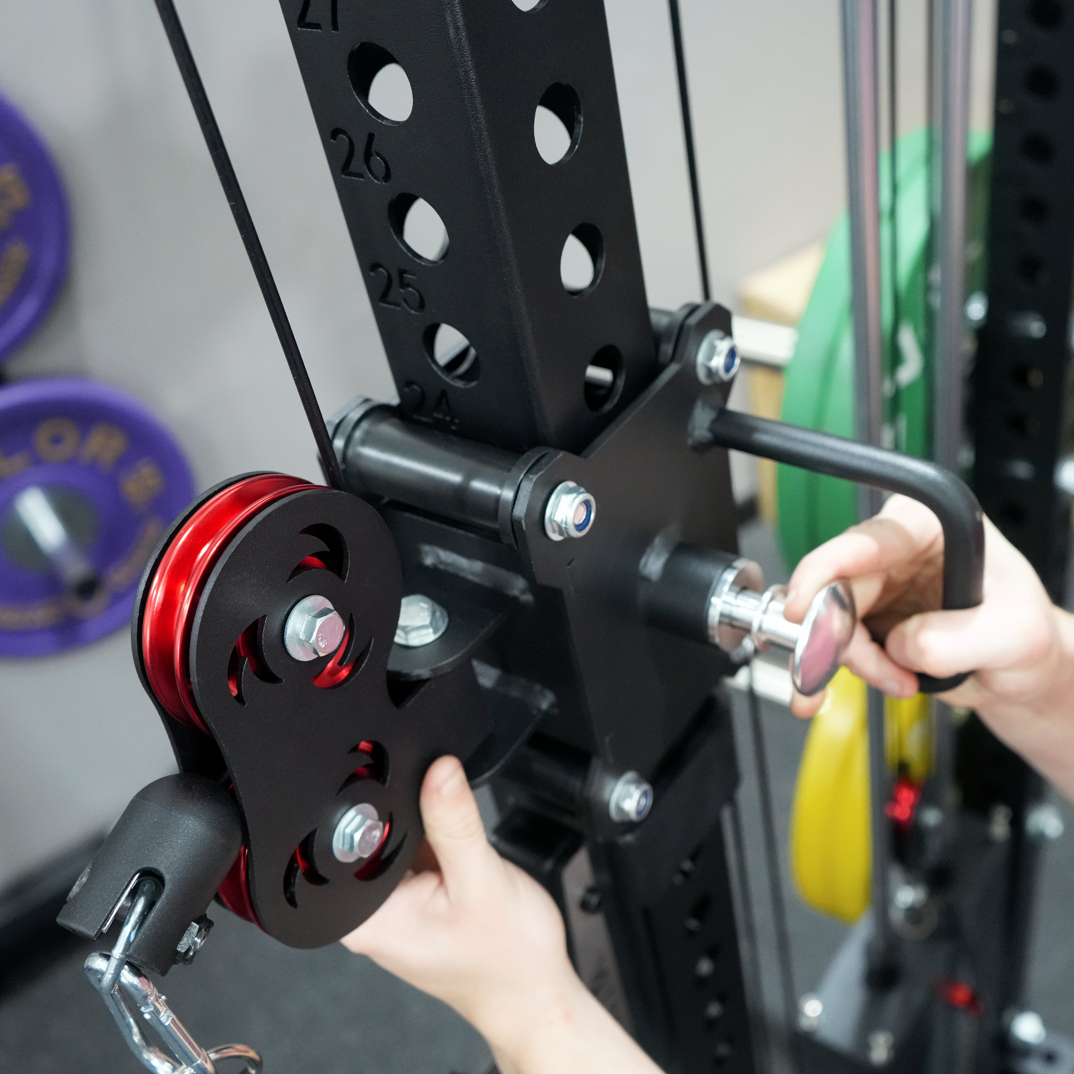 Close up view of the Valor Fitness BD-83 adjustable cable pulley system with numbered uprights and aluminum pulley wheels