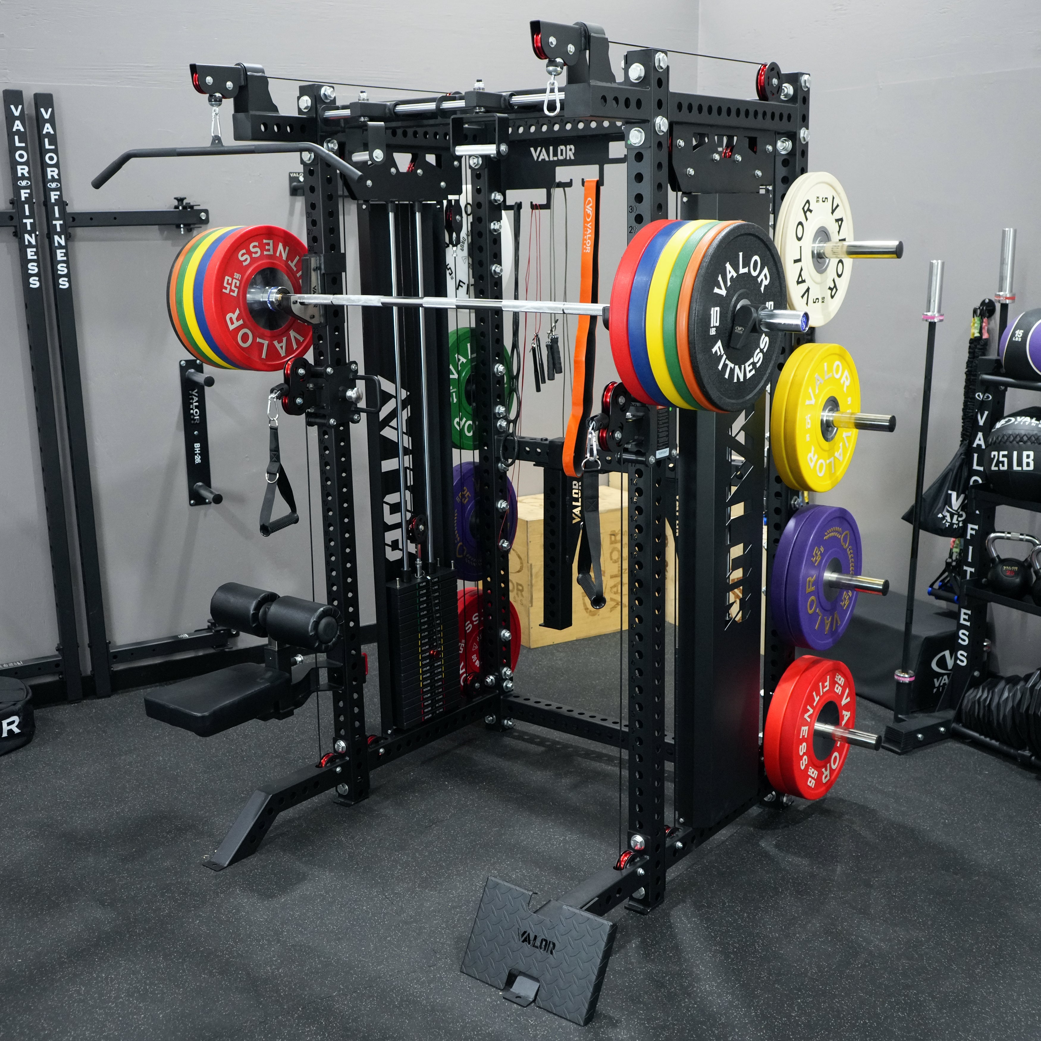 Full view of the Valor Fitness BD-83 functional trainer power rack with dual weight stacks, Olympic barbell, plate storage pegs, pull up bar, lat pulldown seat, and cable pulley system in gym setting