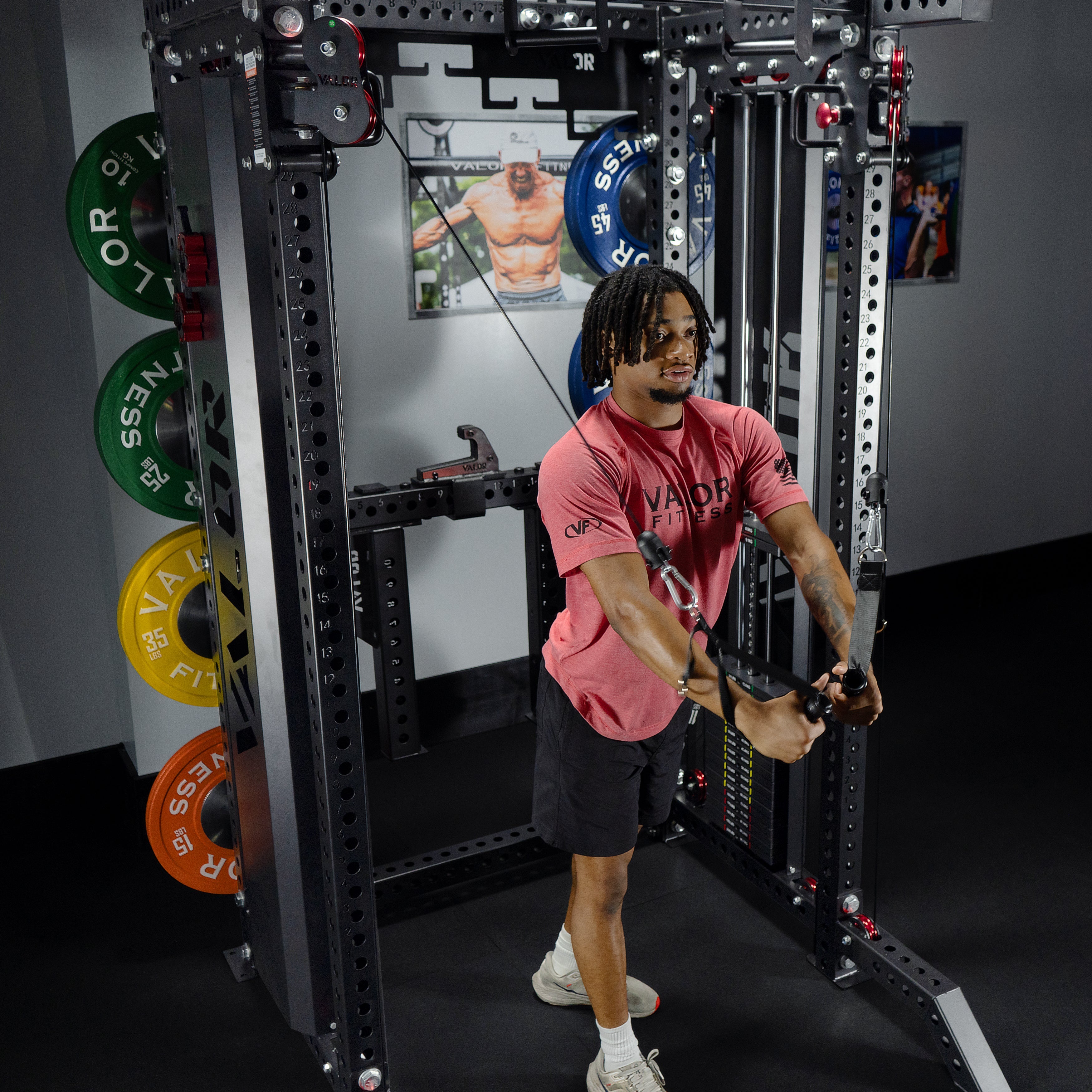 Athlete performing standing cable chest fly exercise on the Valor Fitness BD-83 functional trainer power rack using adjustable dual pulleys