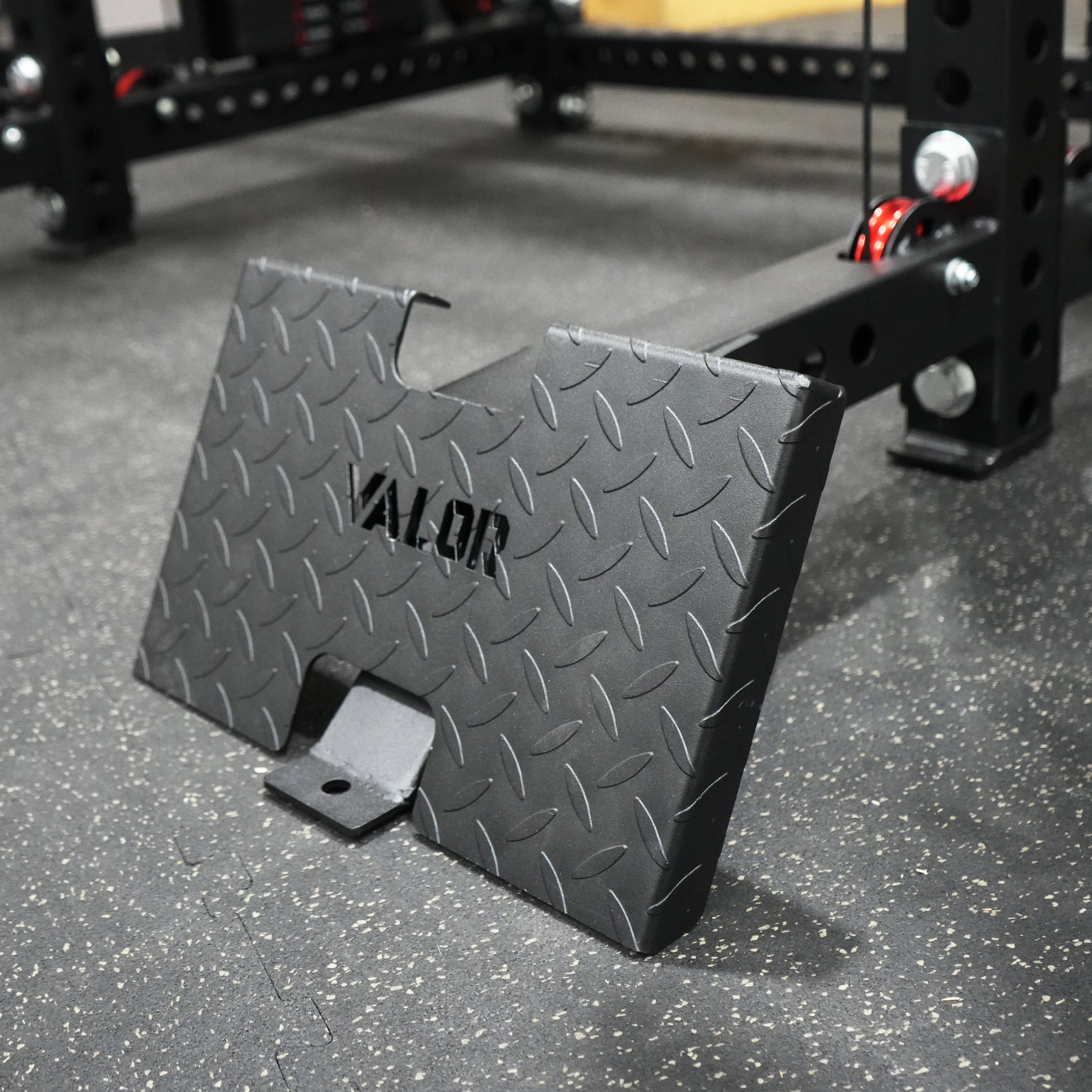 Close up view of the Valor Fitness BD-83 low row footplate attachment with diamond tread steel surface for seated cable row exercises