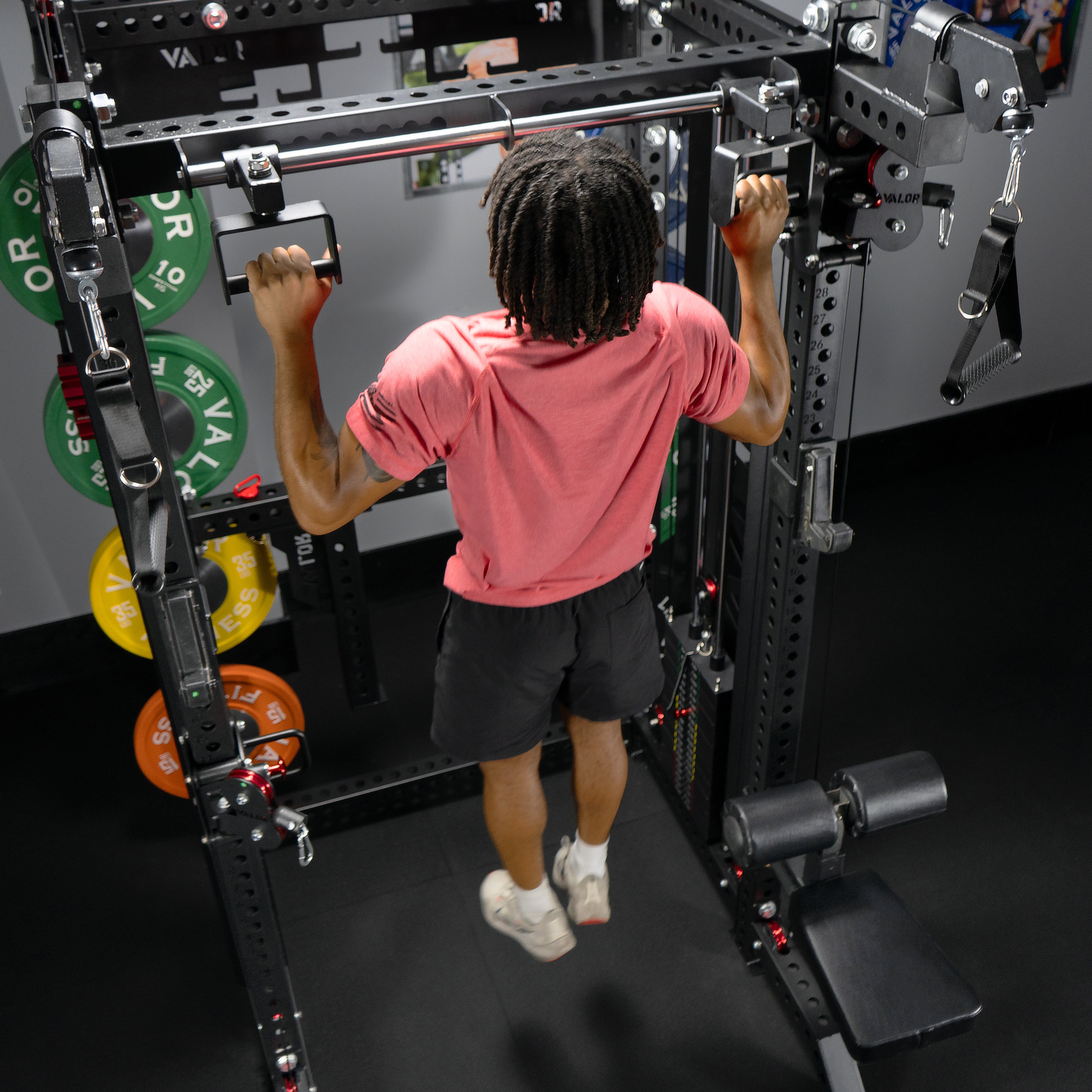 Athlete performing pull ups on the Valor Fitness BD-83 functional trainer power rack using multi grip pull up handles