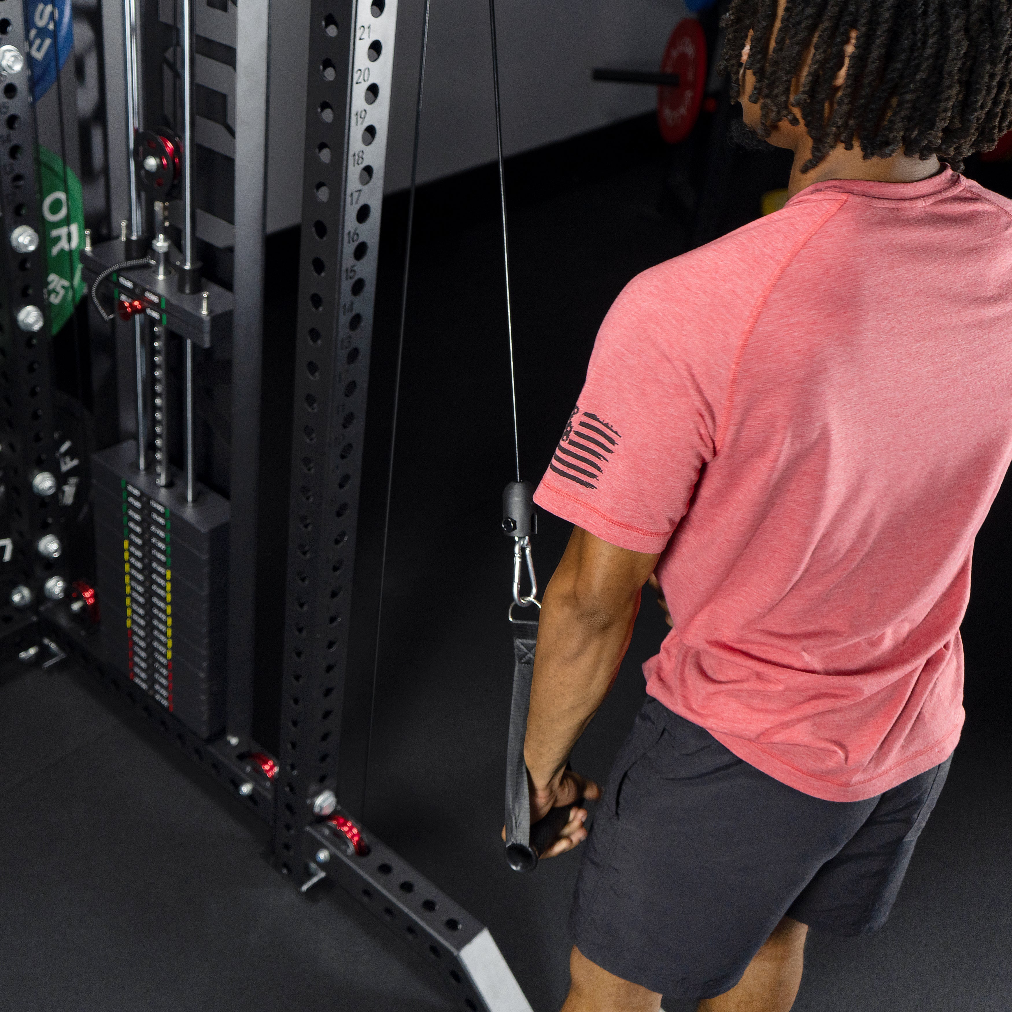 Athlete performing single arm cable tricep pushdowns on the Valor Fitness BD-83 functional trainer using adjustable pulley system and cable handle