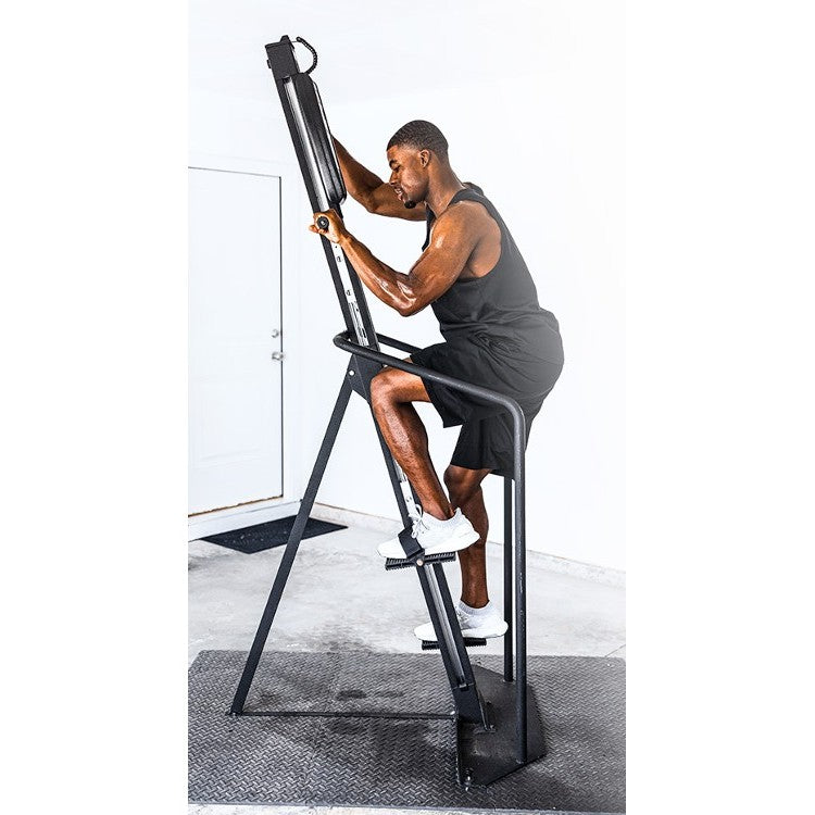 Athlete using VersaClimber Home Touchscreen H-TS vertical climber for full-body cardio workout