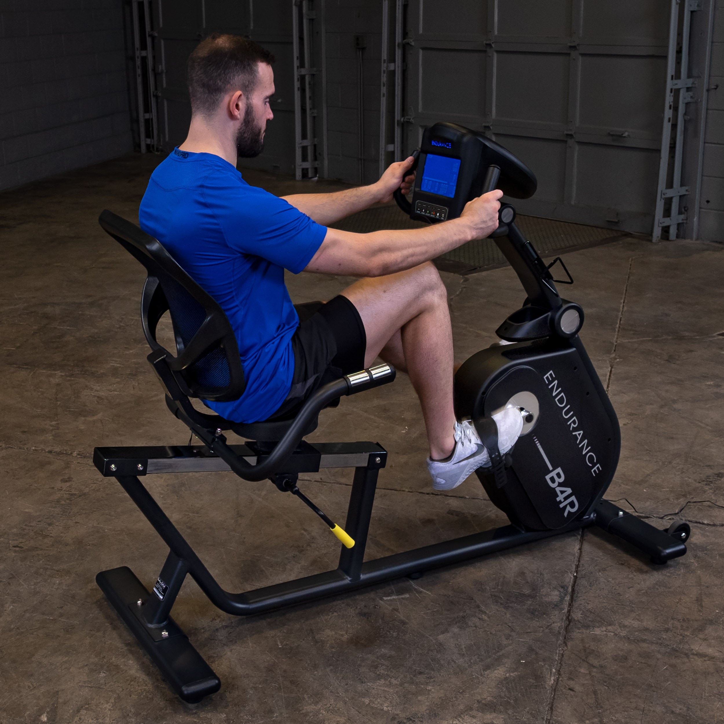 Man using Body-Solid Endurance B4RB recumbent bike for cardio workout