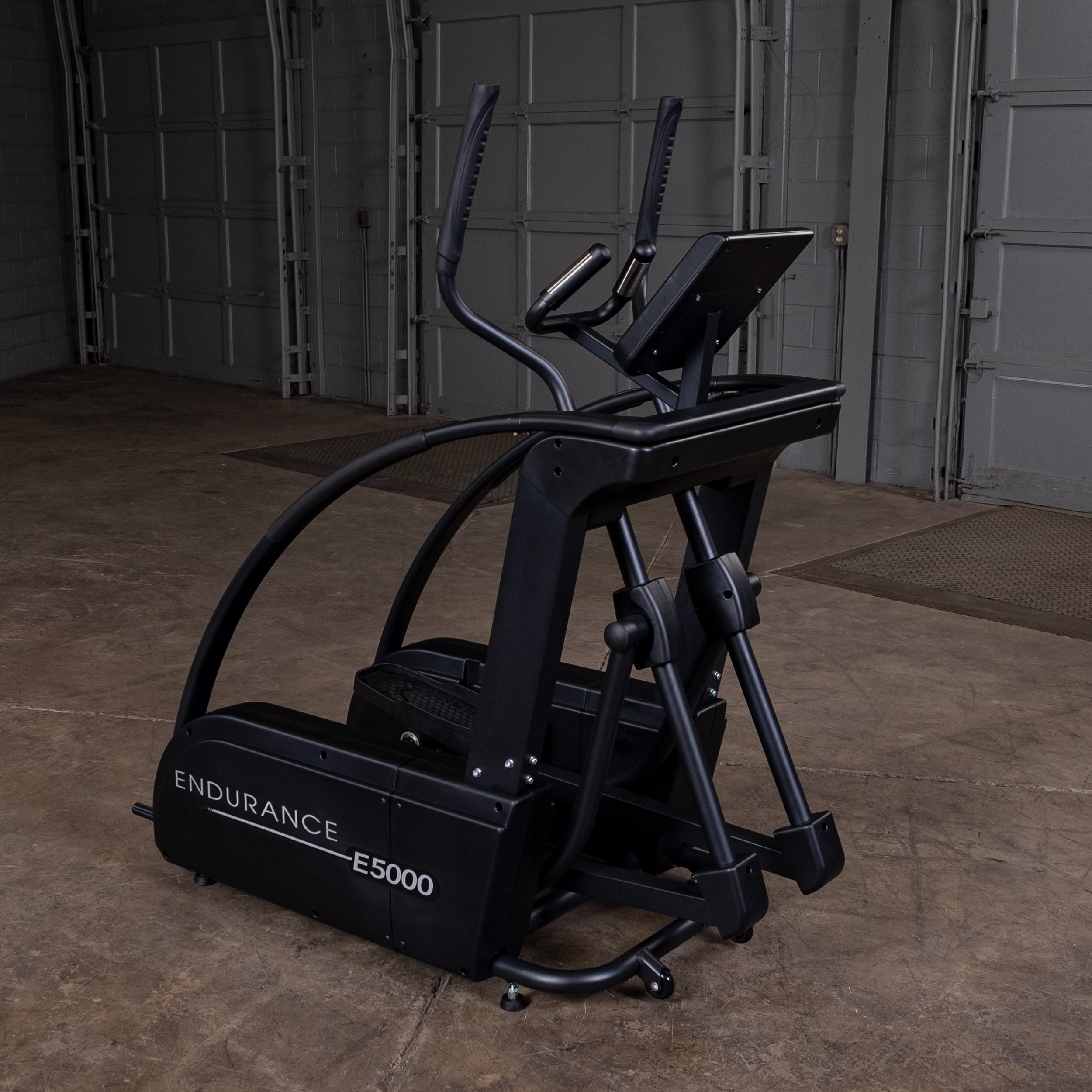 Body-Solid Endurance E5000 elliptical trainer in home gym setting showing self-powered commercial design