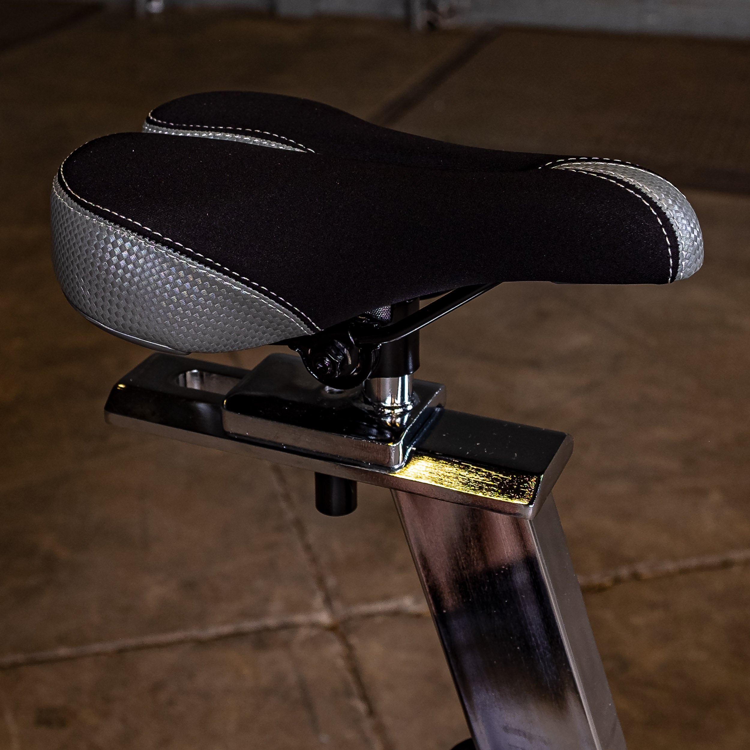 Close-up of the Body-Solid Endurance ESB250 indoor training cycle padded comfort saddle with adjustable seat positioning