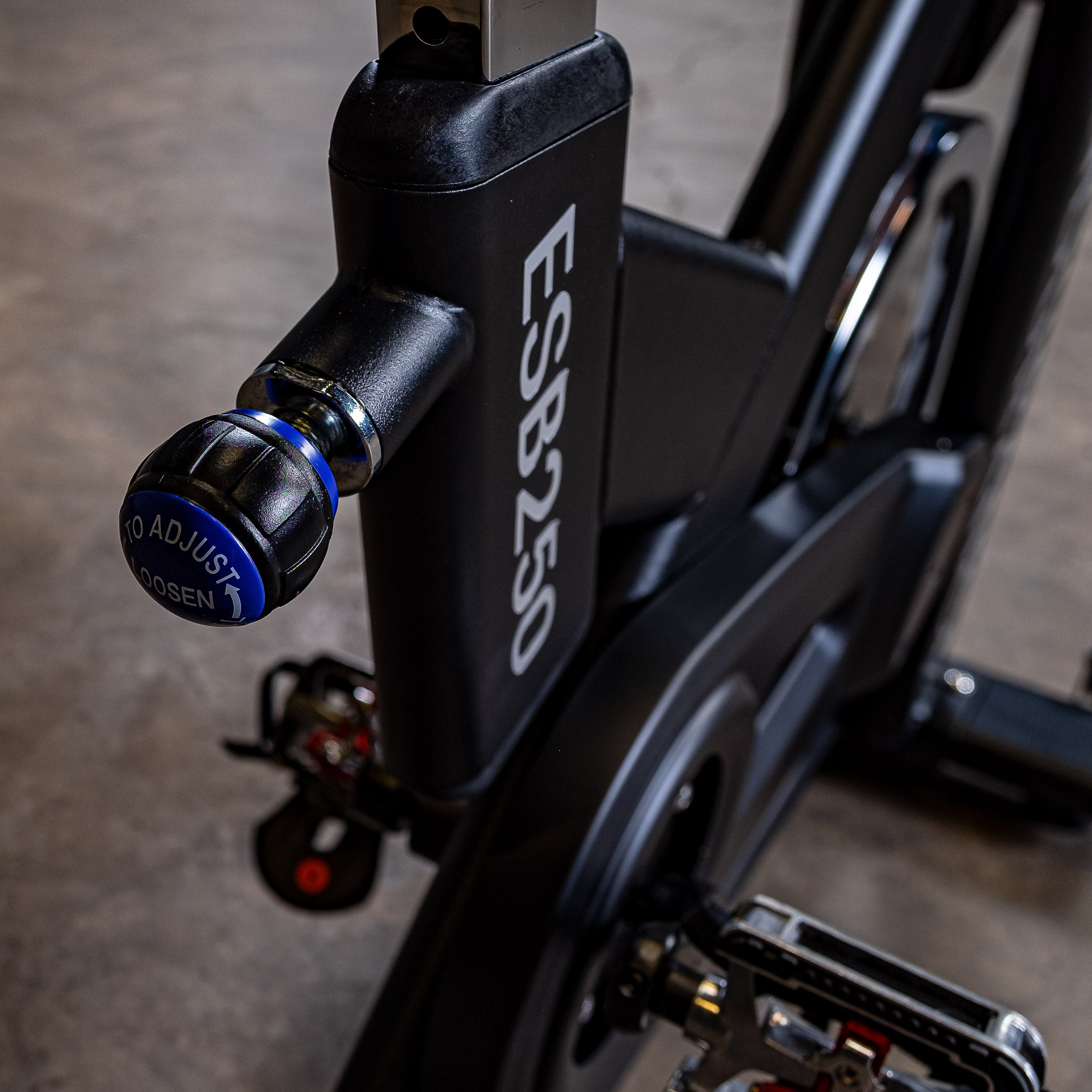 Close-up of the Body-Solid Endurance ESB250 indoor training cycle seat adjustment knob for quick rider positioning