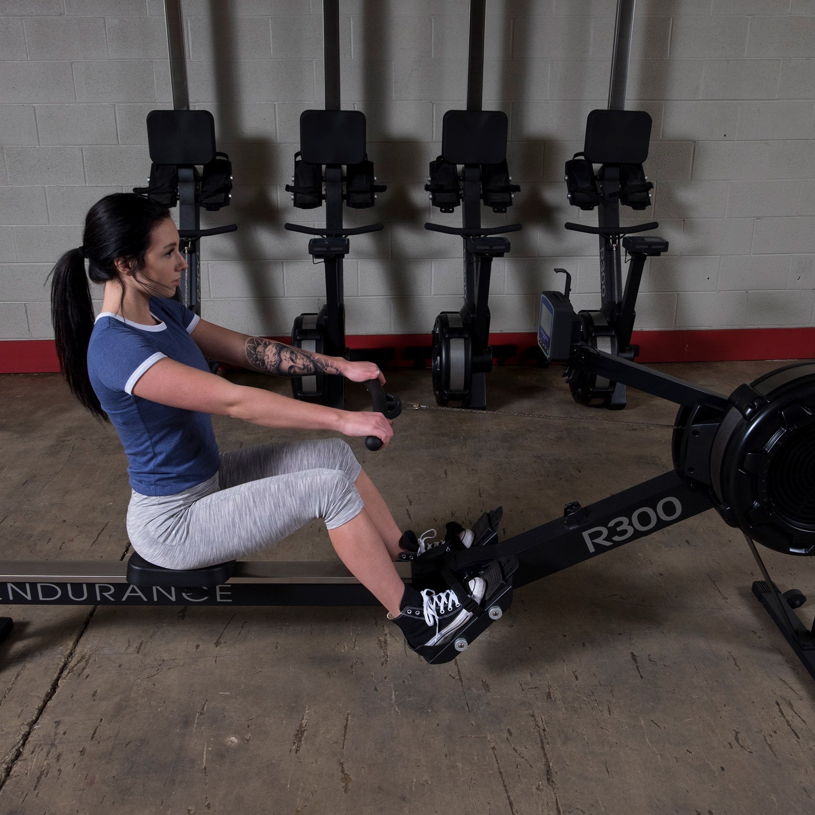 Body Solid Endurance R300 indoor rowing machine in use for full body home gym cardio workout
