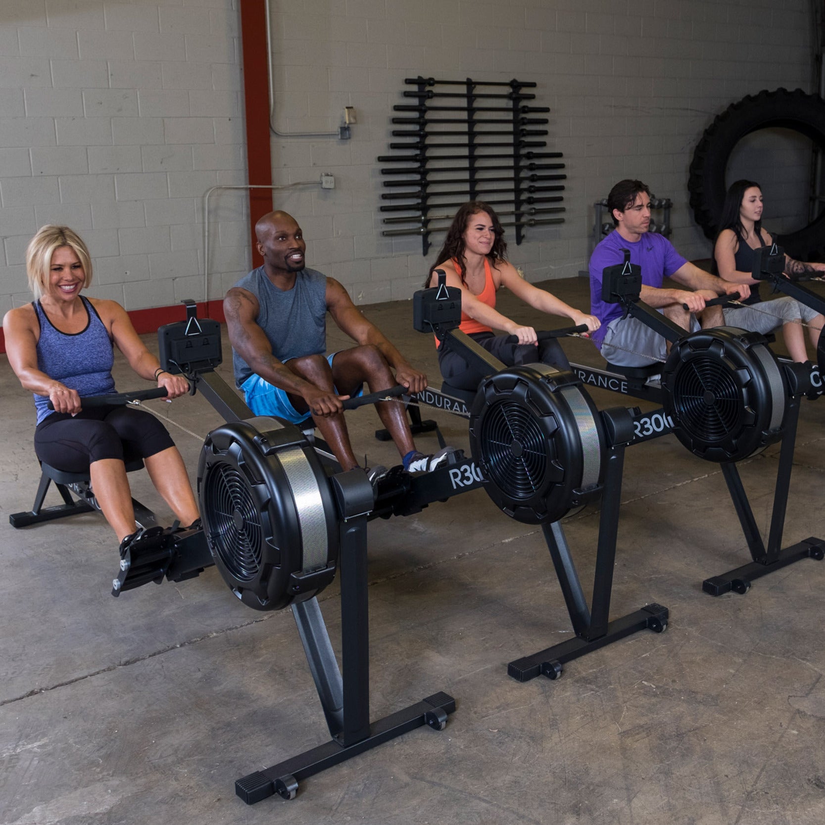 Multiple users training on Body Solid Endurance R300 rowing machines in a commercial gym setting for group cardio workouts