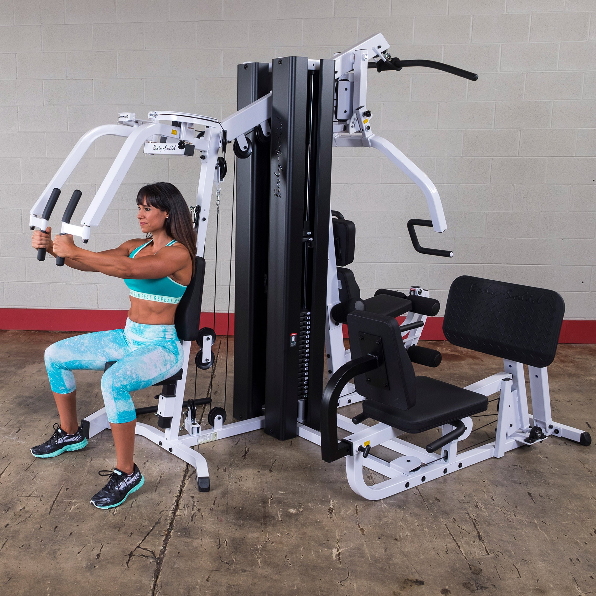 Person performing pec fly exercises on the Body-Solid EXM3000LPS dual stack multi-station gym
