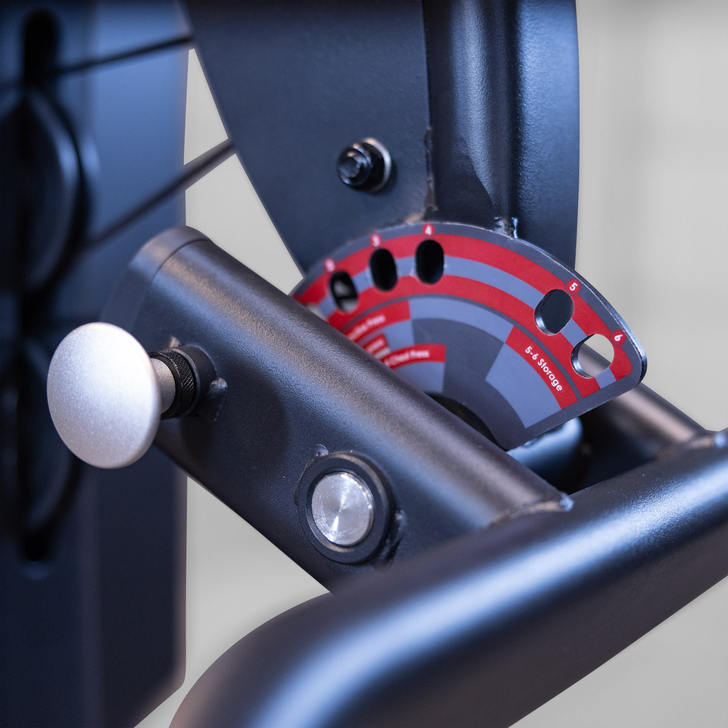 Close-up of the adjustable press arm positioning system on the Body-Solid Fusion 500B Personal Trainer showing multiple exercise angle settings