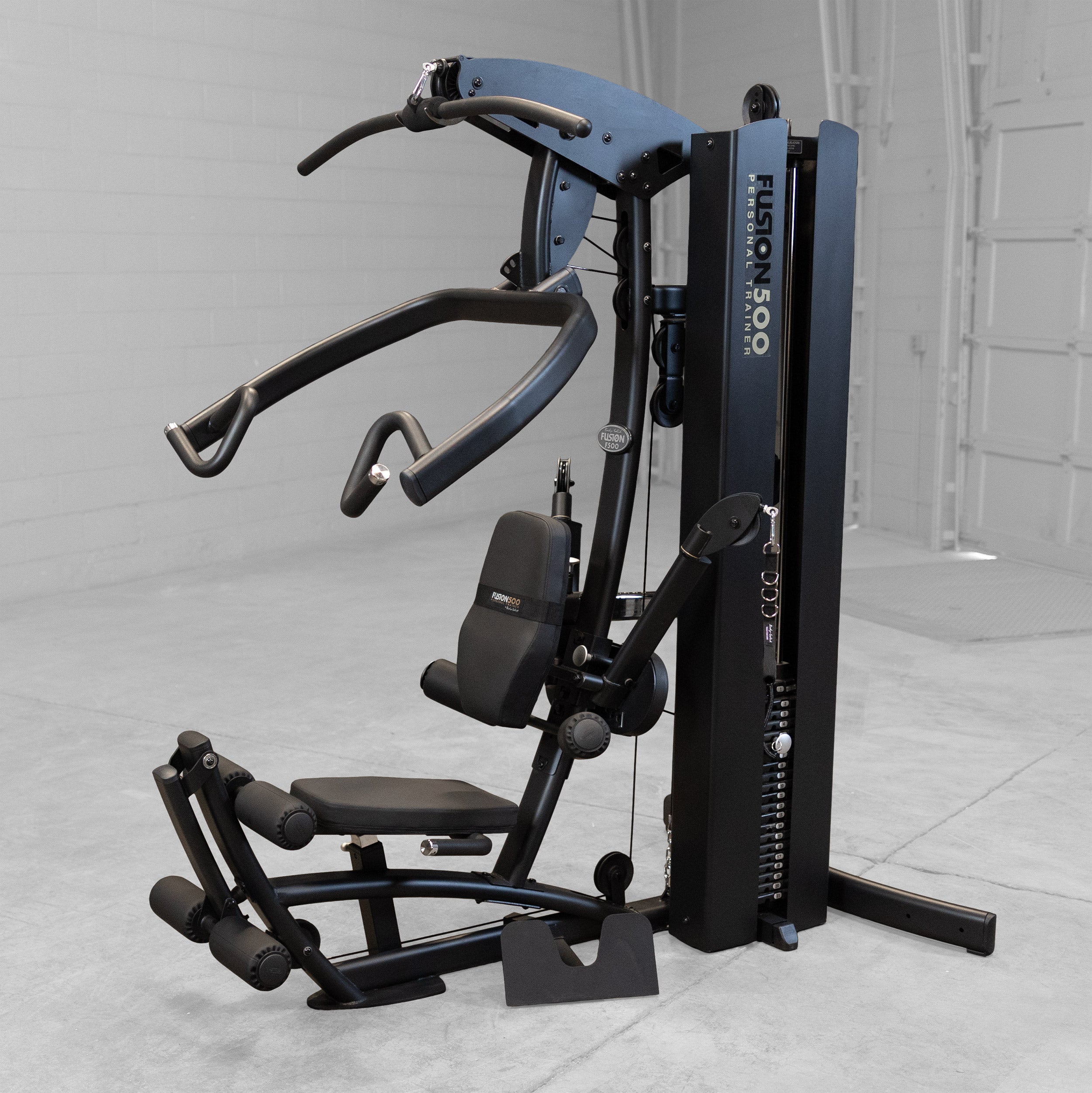Right front angle view of the Body-Solid Fusion 500B Personal Trainer showing the articulating press arms adjustable seat leg developer lat pulldown station and weight stack
