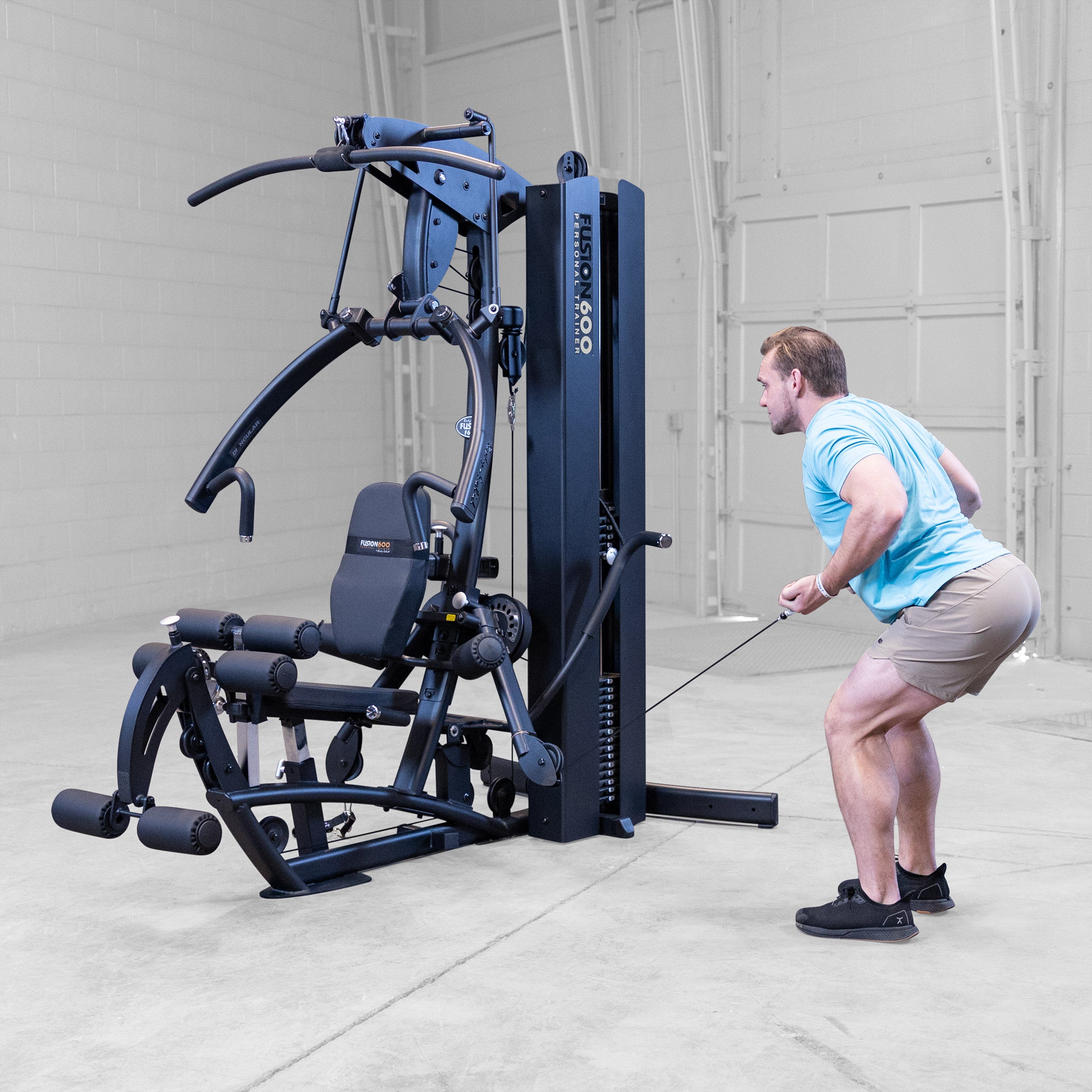 Man performing a bent over row on the Body-Solid Fusion 600B Personal Trainer