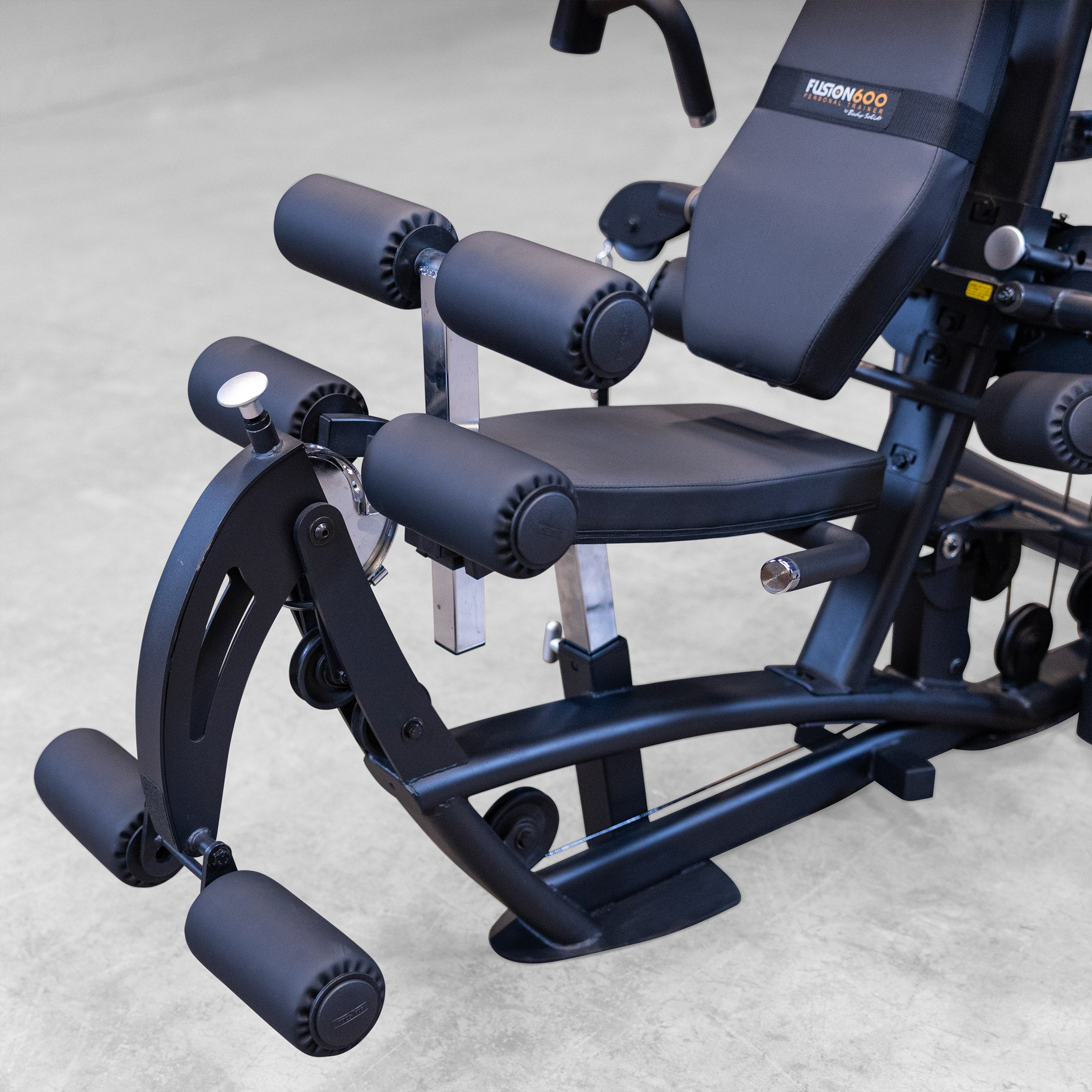 Close-up of the Body-Solid Fusion 600B integrated leg developer with adjustable leg extension and seated leg curl station