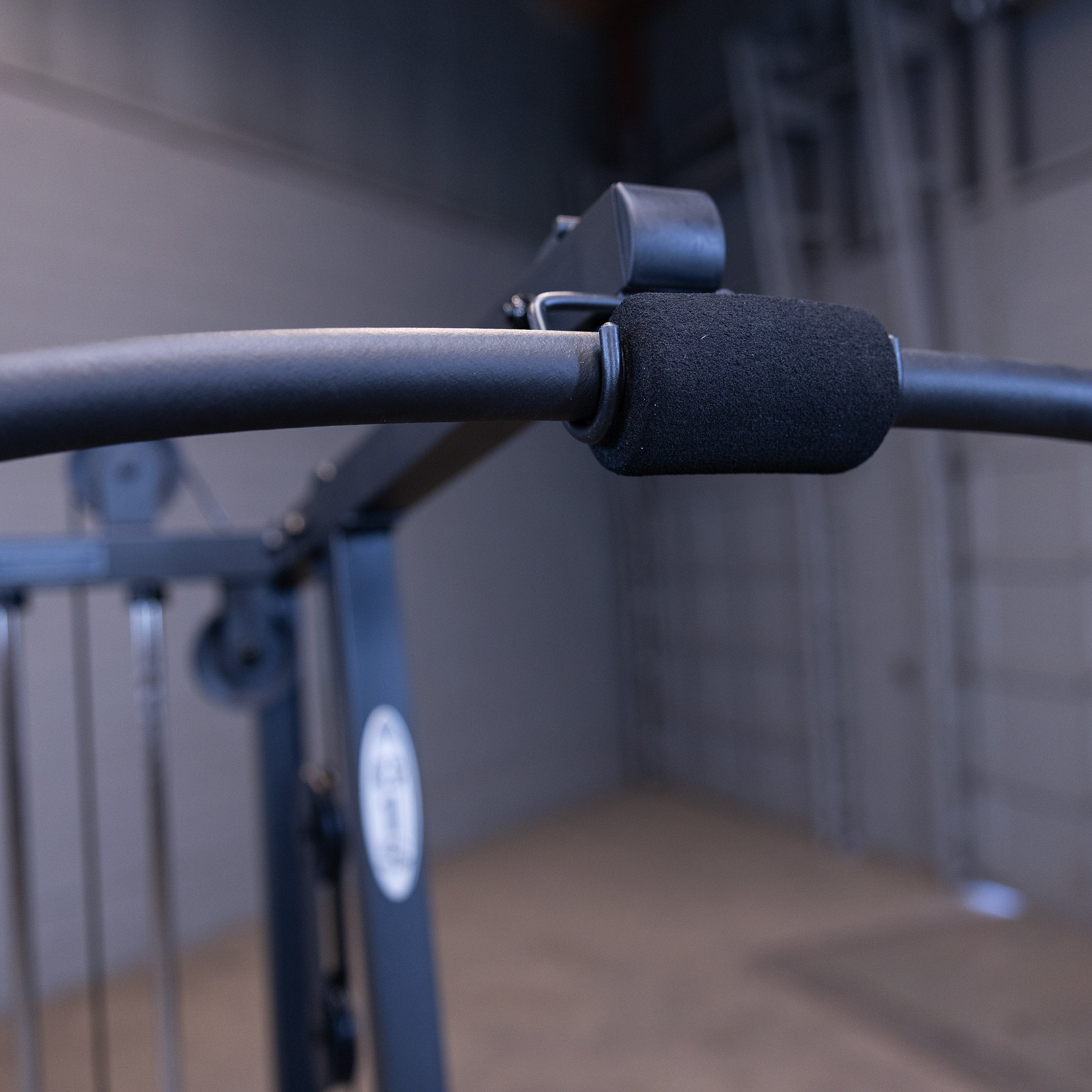 Close up of the Body-Solid G1B lat pulldown bar with foam grips for comfortable upper body strength training