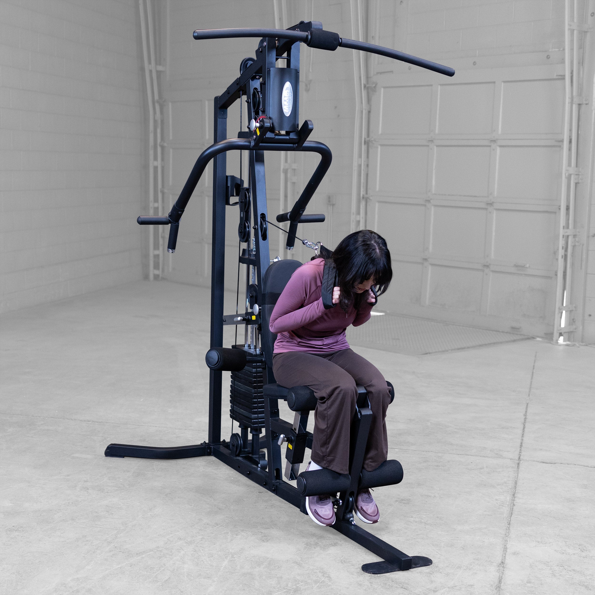 Person performing cable ab crunches on the Body-Solid G3B multi station home gym to strengthen the core and abdominal muscles