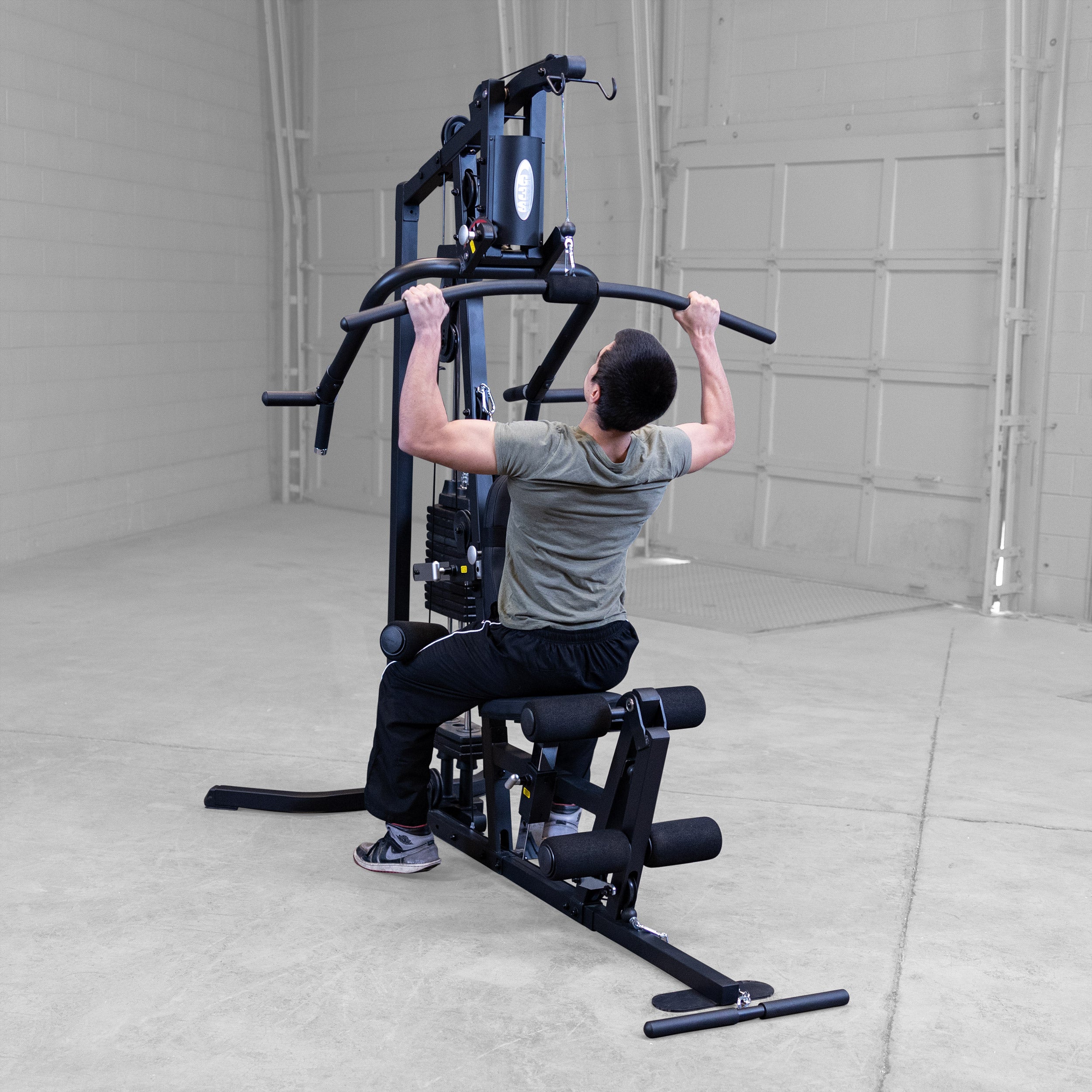 Person performing lat pulldowns on the Body-Solid G3B multi station home gym to strengthen the back and upper body
