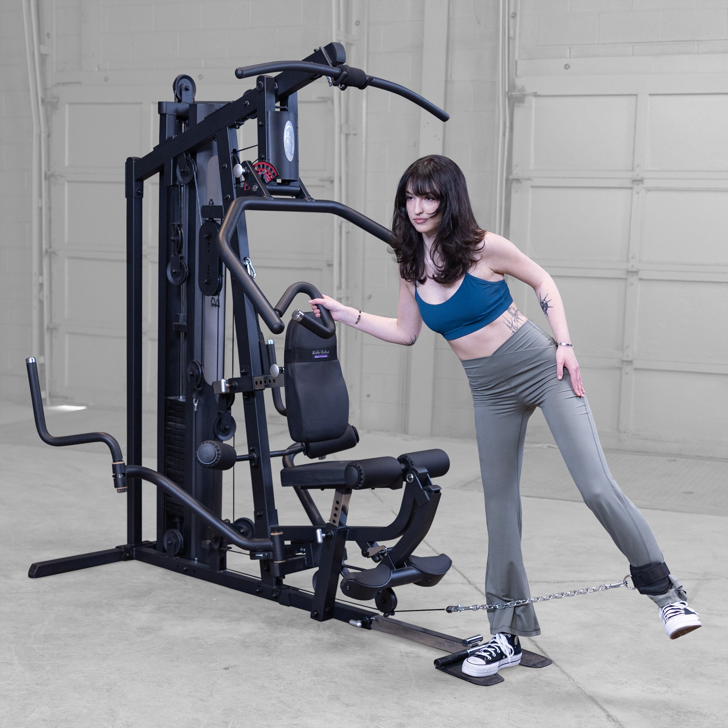 Person performing standing hip abduction on the Body-Solid G5B multi station home gym to strengthen the glutes and outer hips