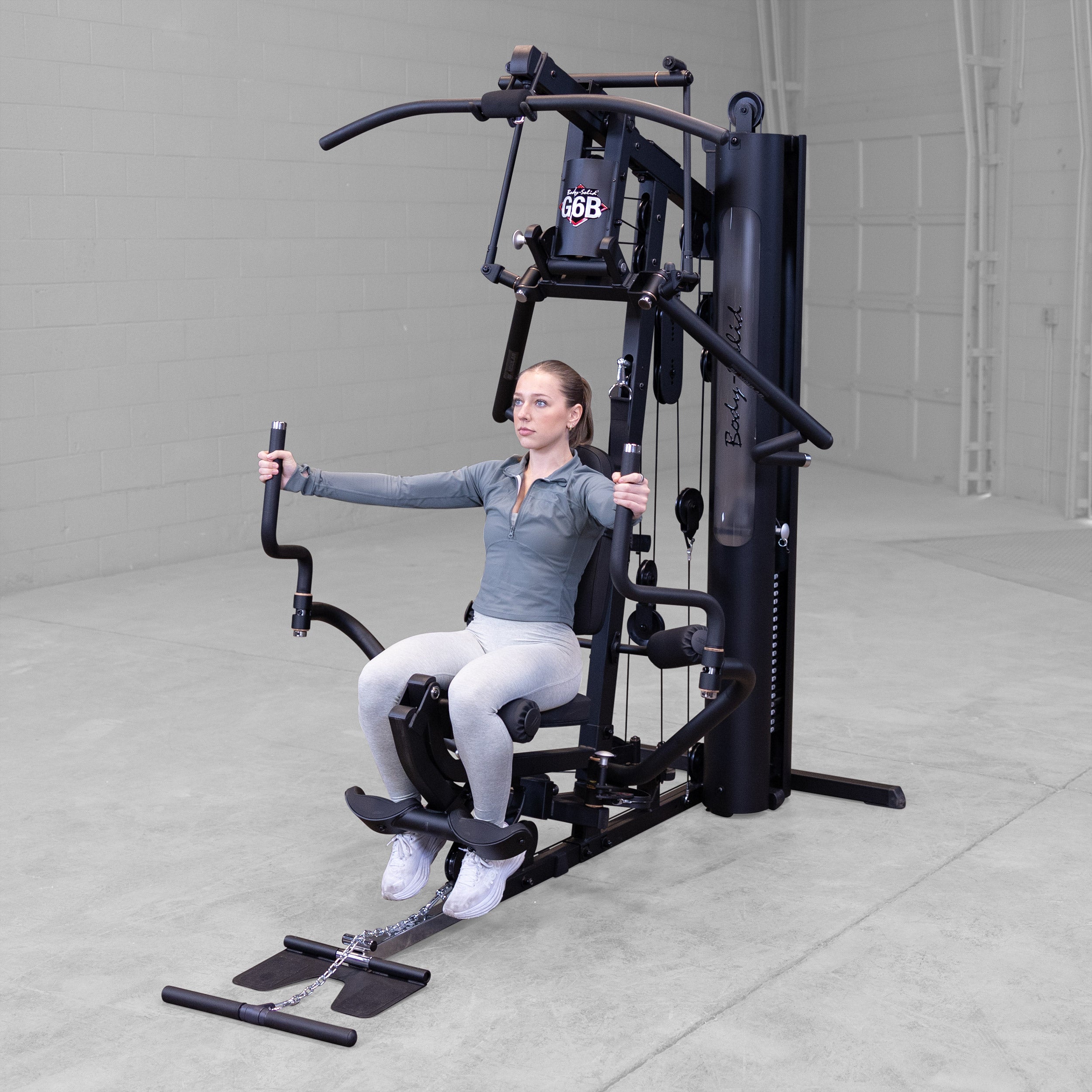 Person performing a pec fly exercise on the Body-Solid G6B Bi-Angular home gym