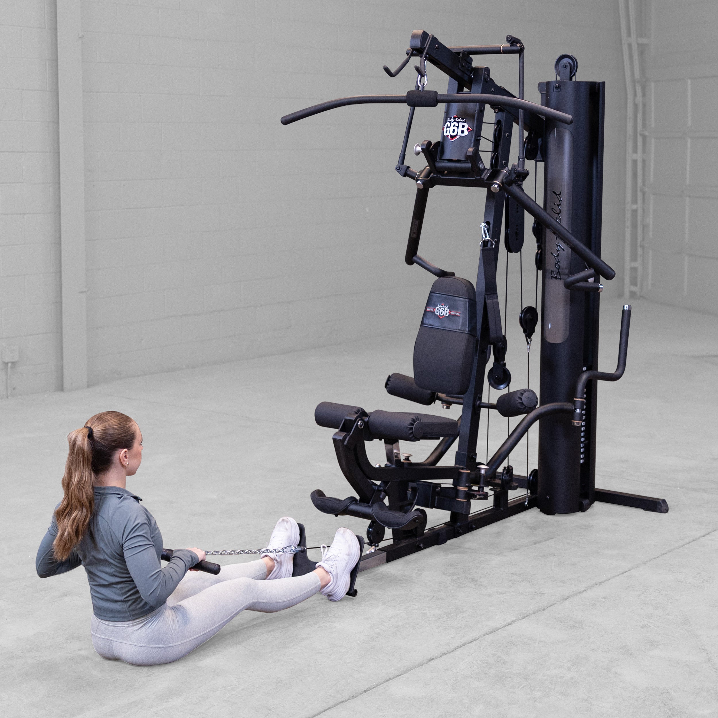 Person performing a seated cable row exercise on the Body-Solid G6B Bi-Angular home gym