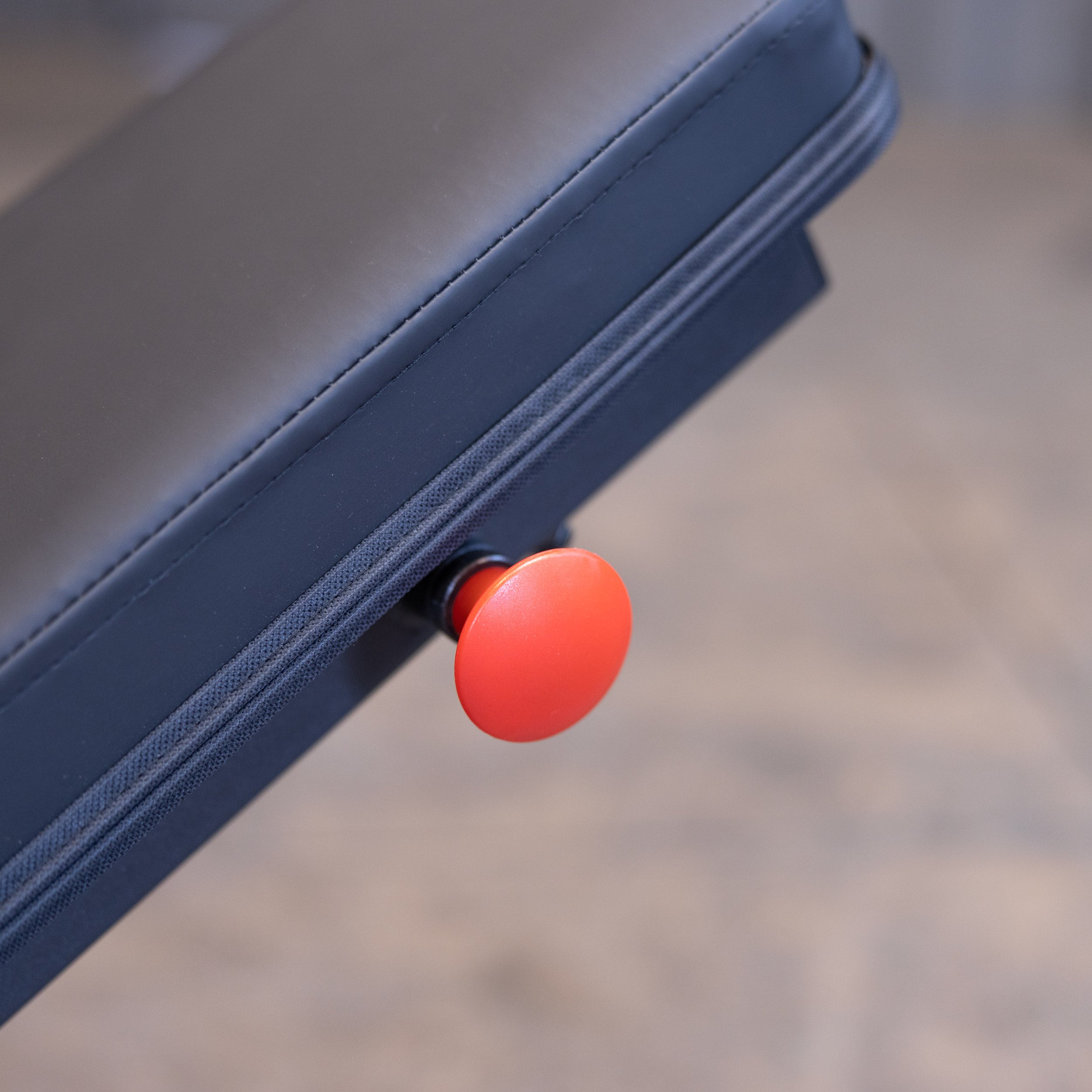 Close up of the Body Solid GFID225B adjustment pop pin for quick bench angle changes