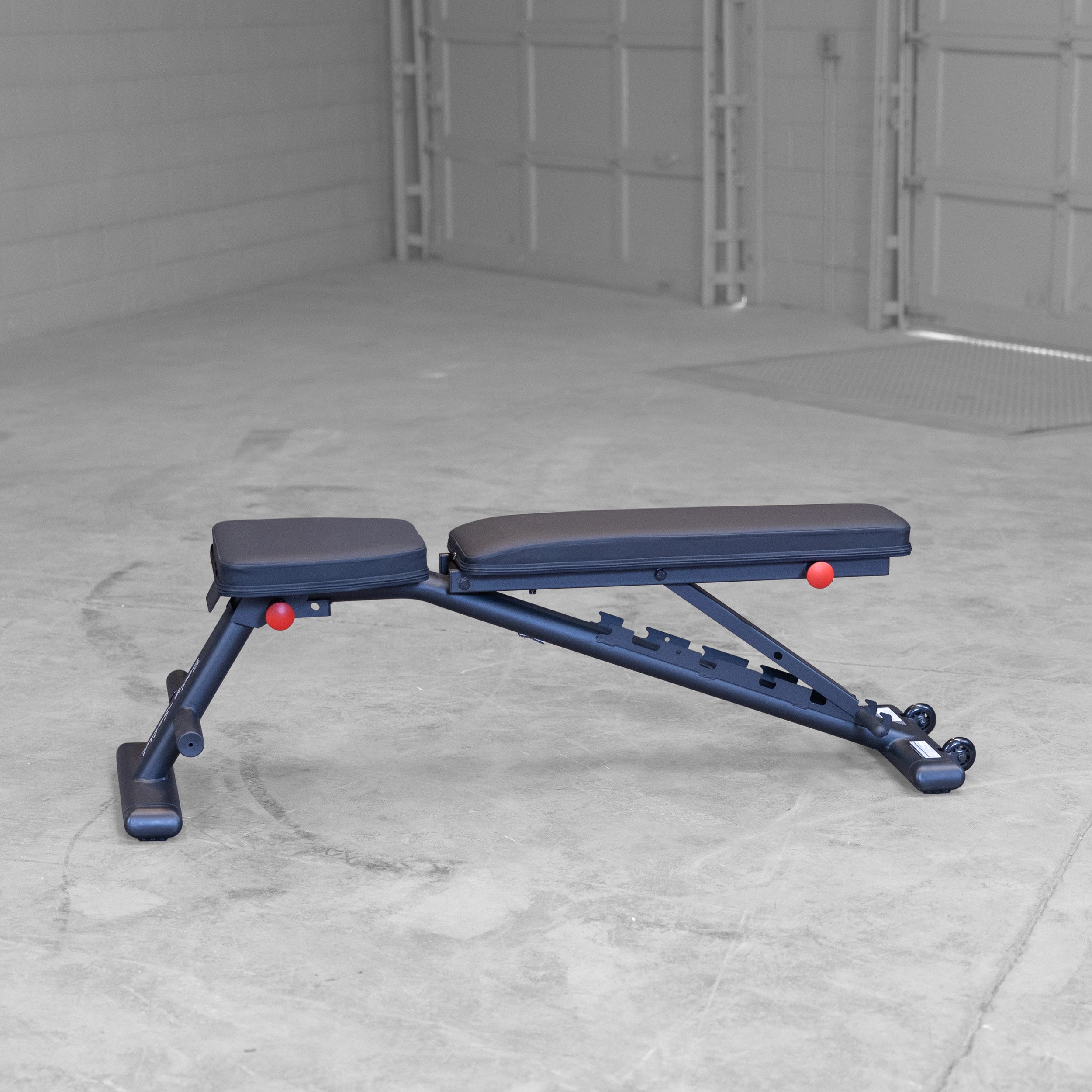 Body Solid GFID225B folding adjustable weight bench shown in flat position for home gym strength training
