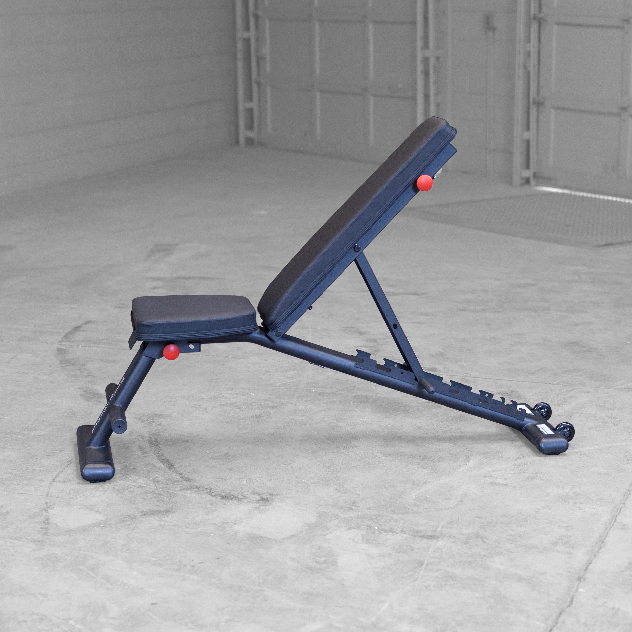 Body Solid GFID225B folding adjustable weight bench shown in high incline position for home gym strength training