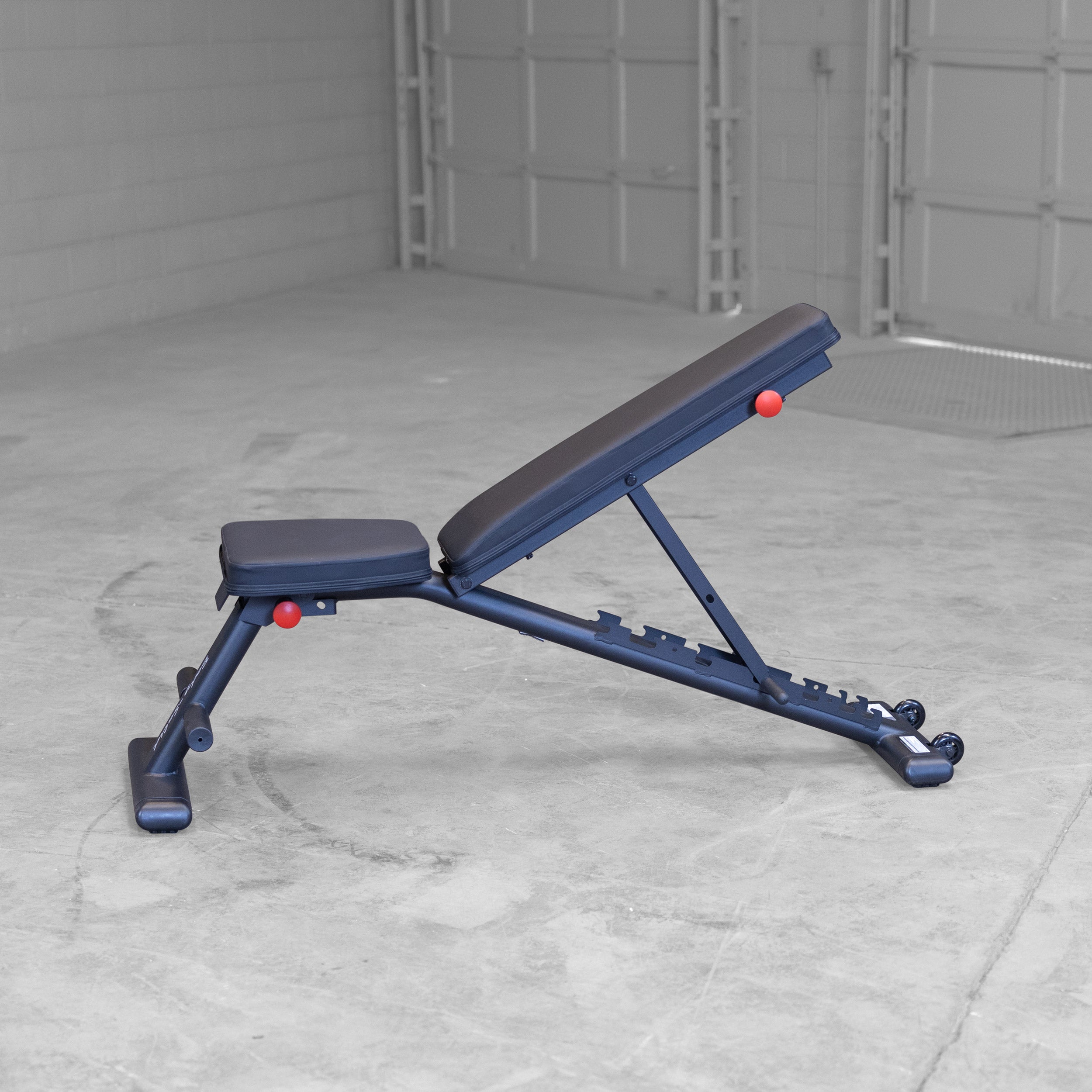 Body Solid GFID225B folding adjustable weight bench shown in medium incline position for home gym strength training