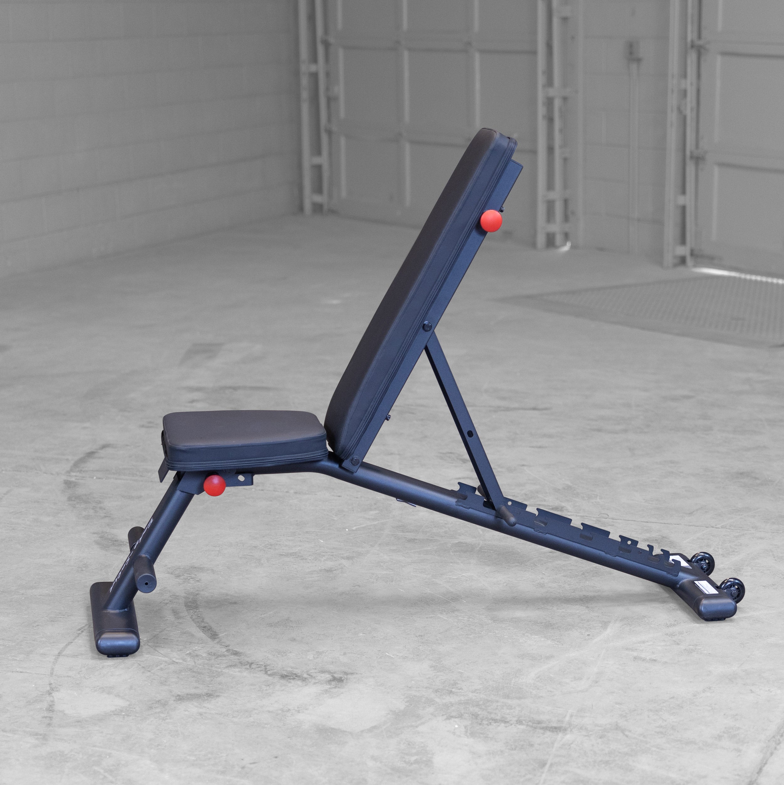 Body Solid GFID225B folding adjustable weight bench shown in upright position for home gym strength training