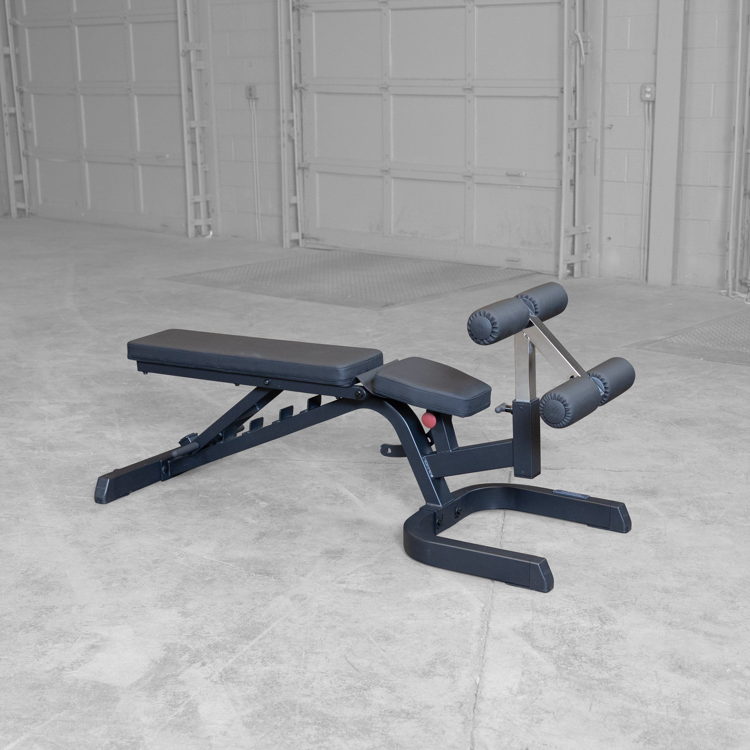 Body-Solid GFID71B Heavy Duty Flat Incline Decline Bench shown with the seat pad in the decline position and integrated leg hold-down attachment
