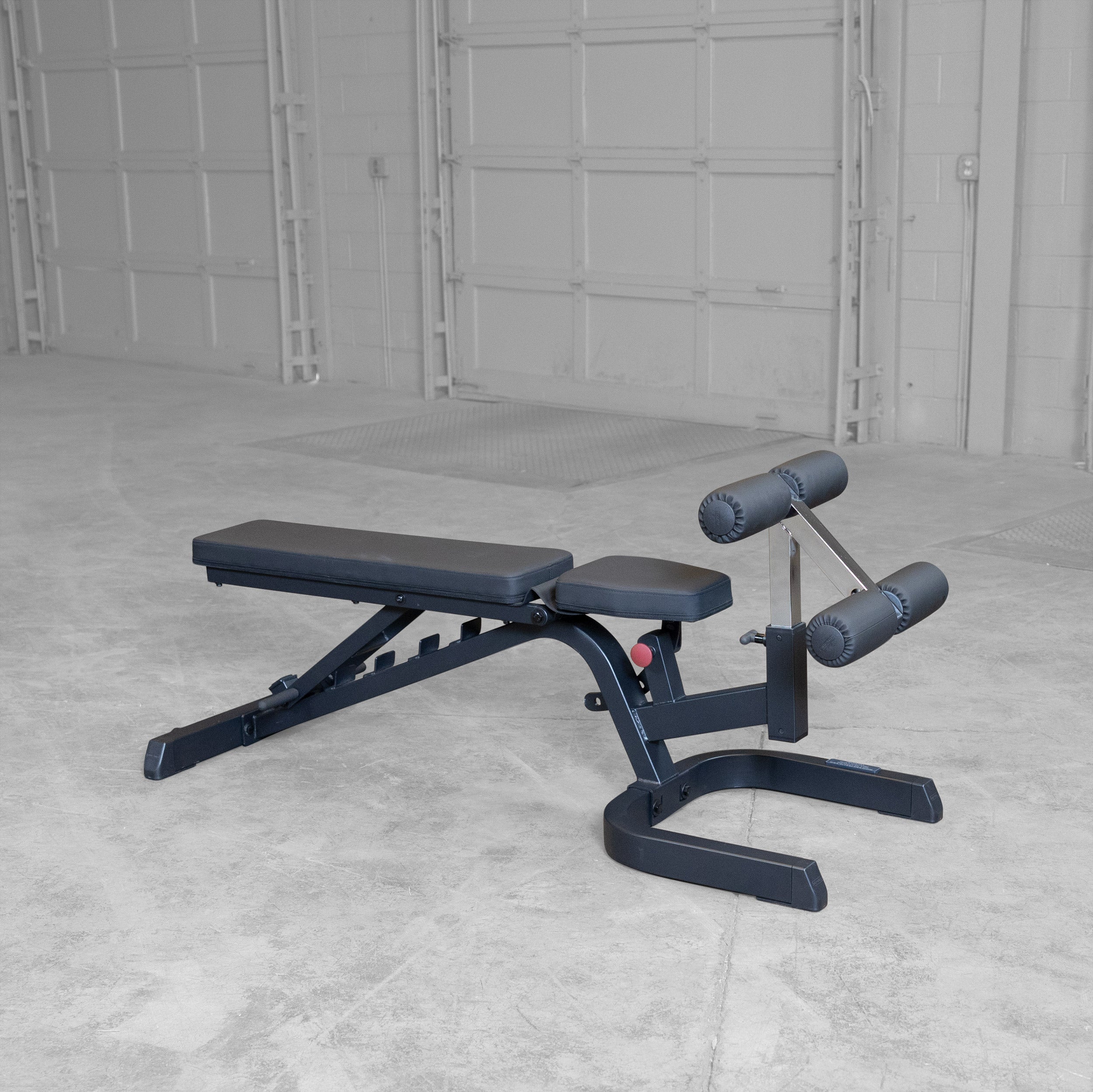 Body-Solid GFID71B Heavy Duty Flat Incline Decline Bench shown in the flat position with integrated leg hold-down attachment and commercial-grade steel frame