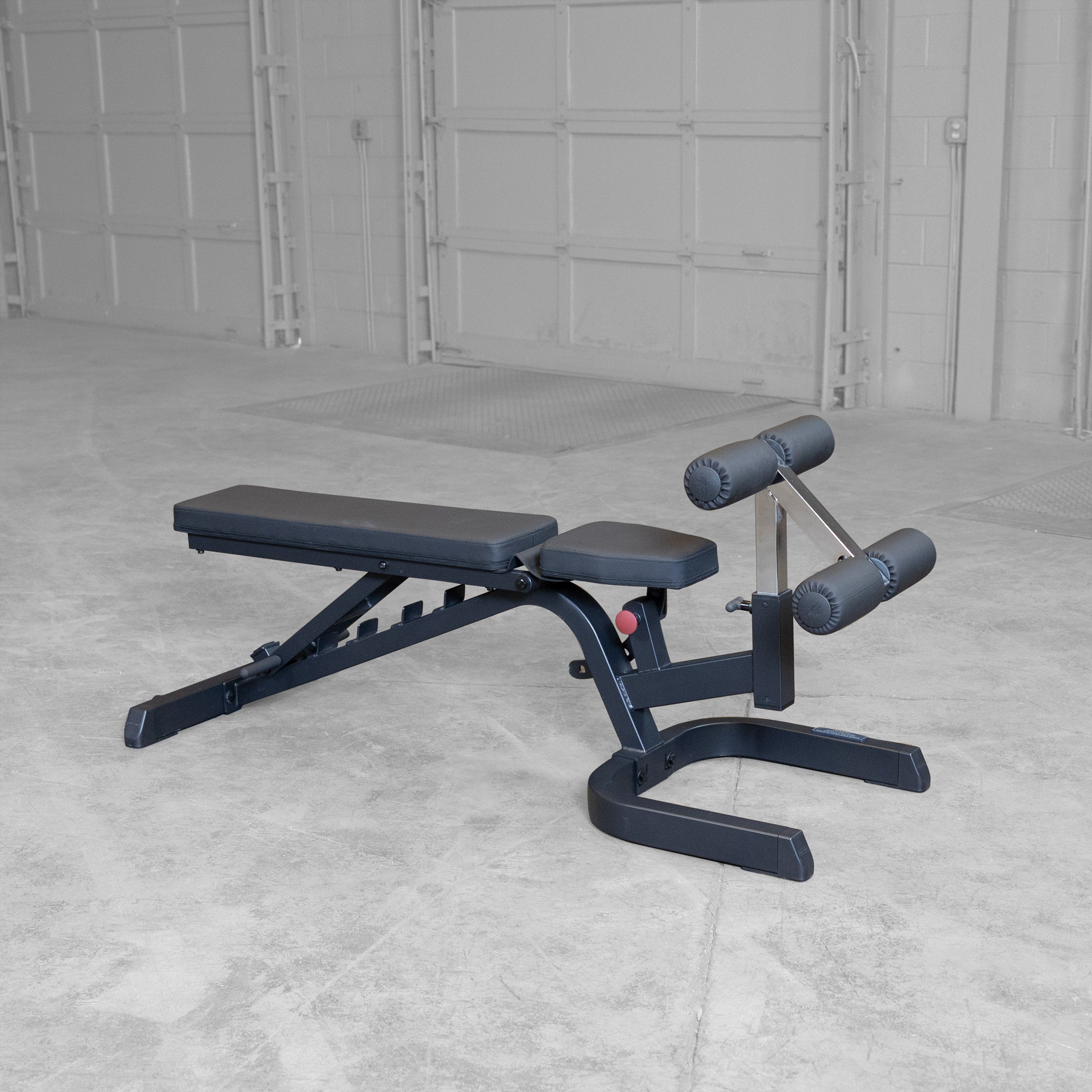 Body-Solid GFID71B Heavy Duty Flat Incline Decline Bench shown with the seat pad adjusted to the flat position and integrated leg hold-down attachment