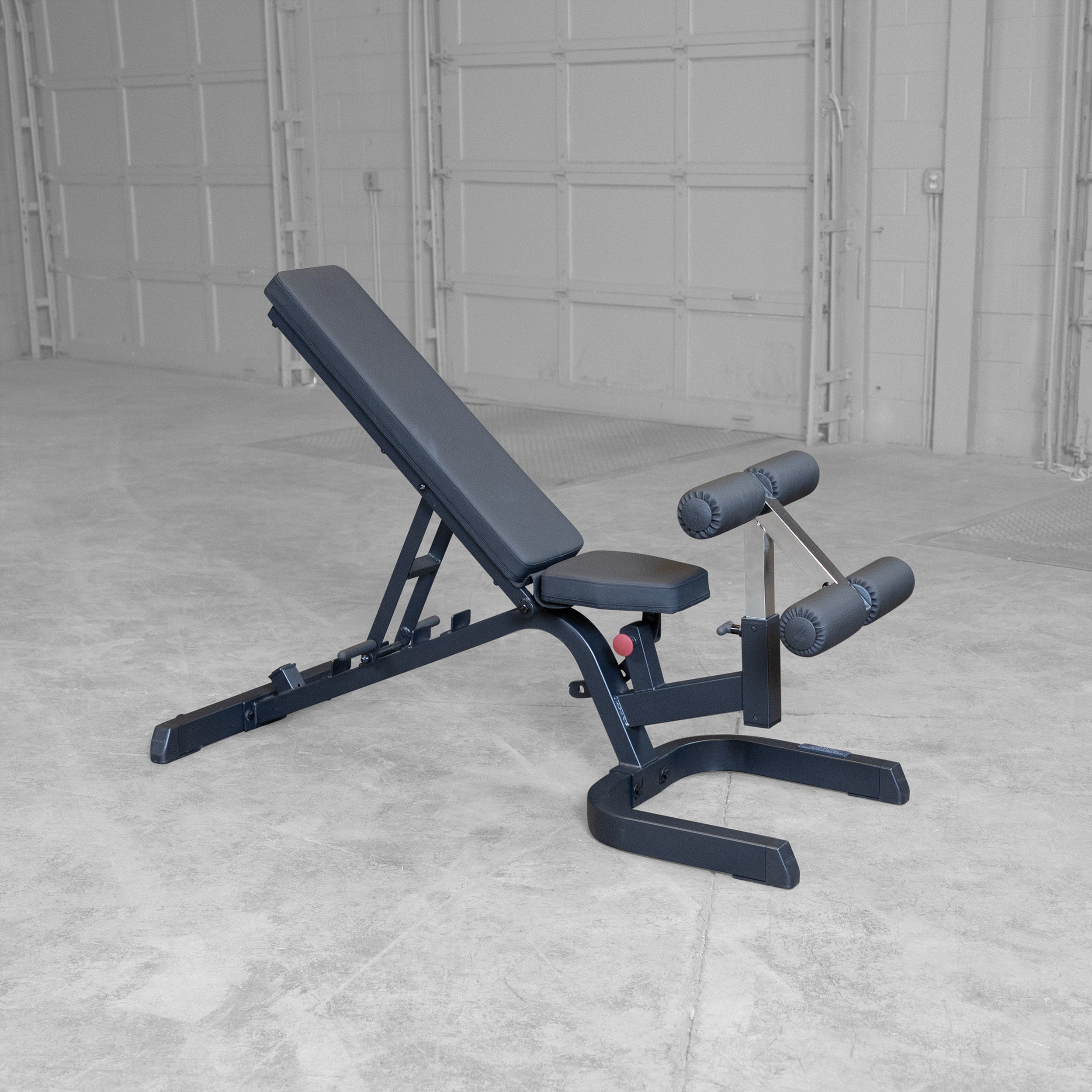 Body-Solid GFID71B Heavy Duty Flat Incline Decline Bench shown in a high incline position with integrated leg hold-down attachment and commercial-grade steel frame