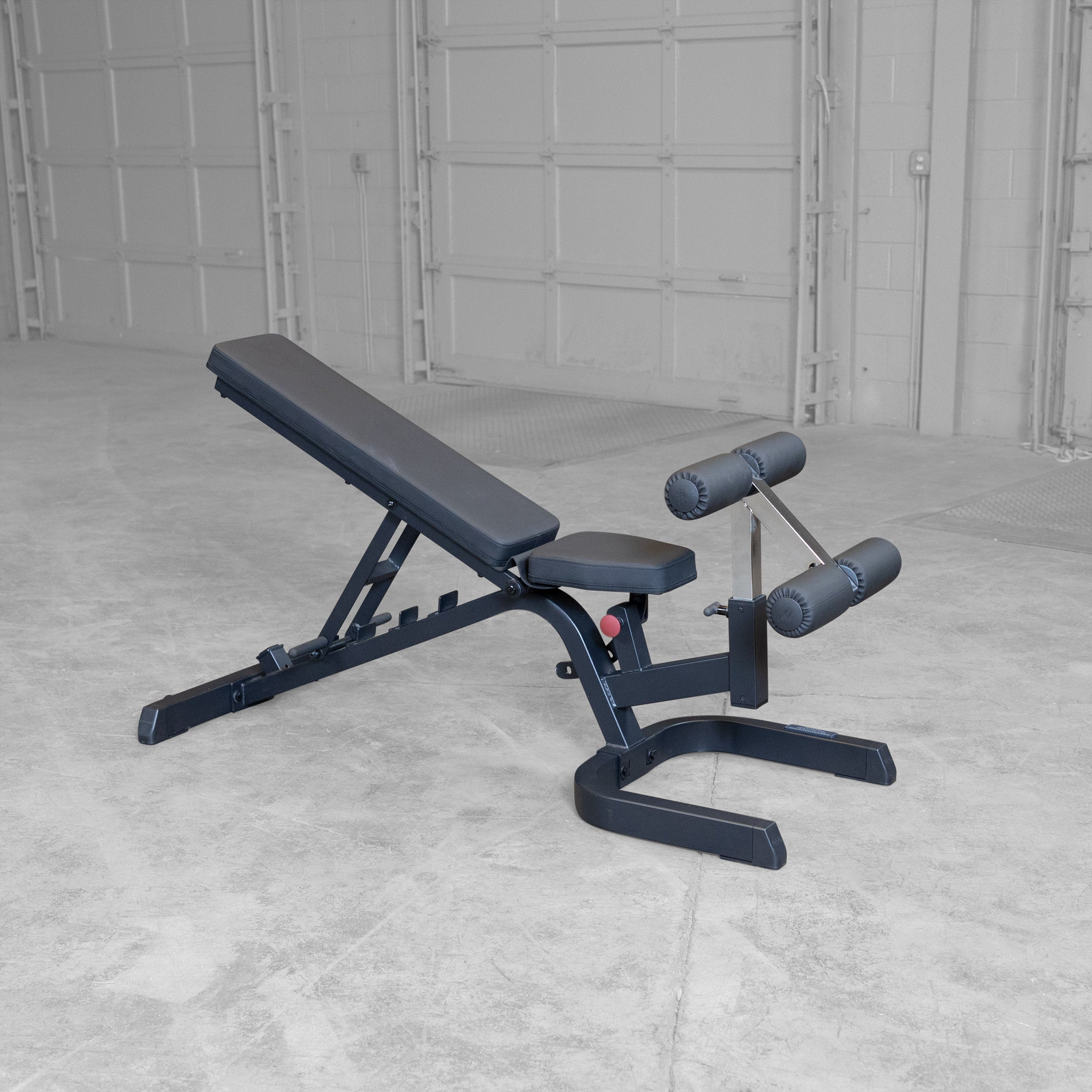 Body-Solid GFID71B Heavy Duty Flat Incline Decline Bench shown in an incline position with integrated leg hold-down attachment and commercial-grade steel frame