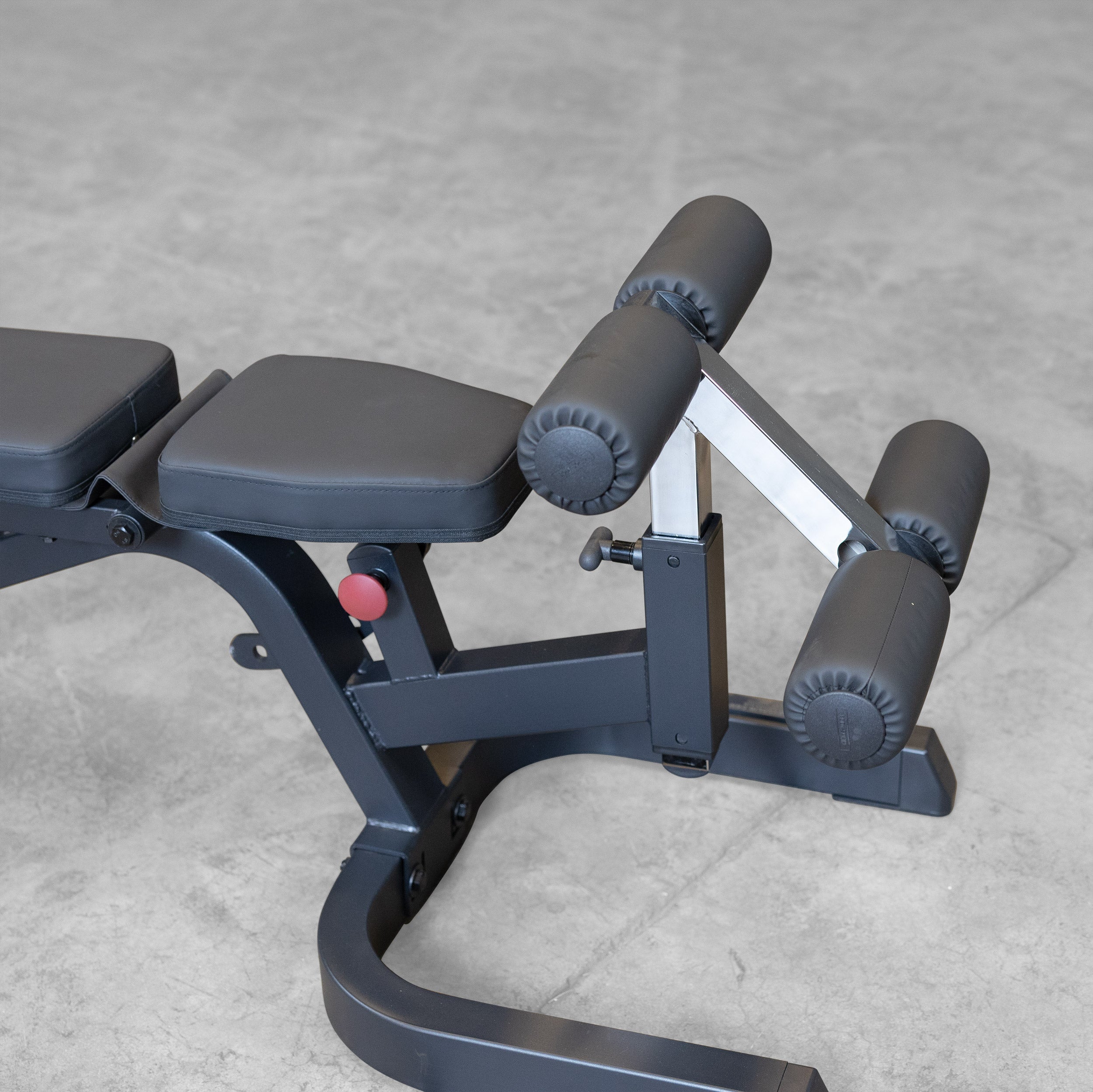 Body-Solid GFID71B Heavy Duty Flat Incline Decline Bench close-up of the adjustable leg hold-down attachment with oversized foam rollers for secure decline exercise support