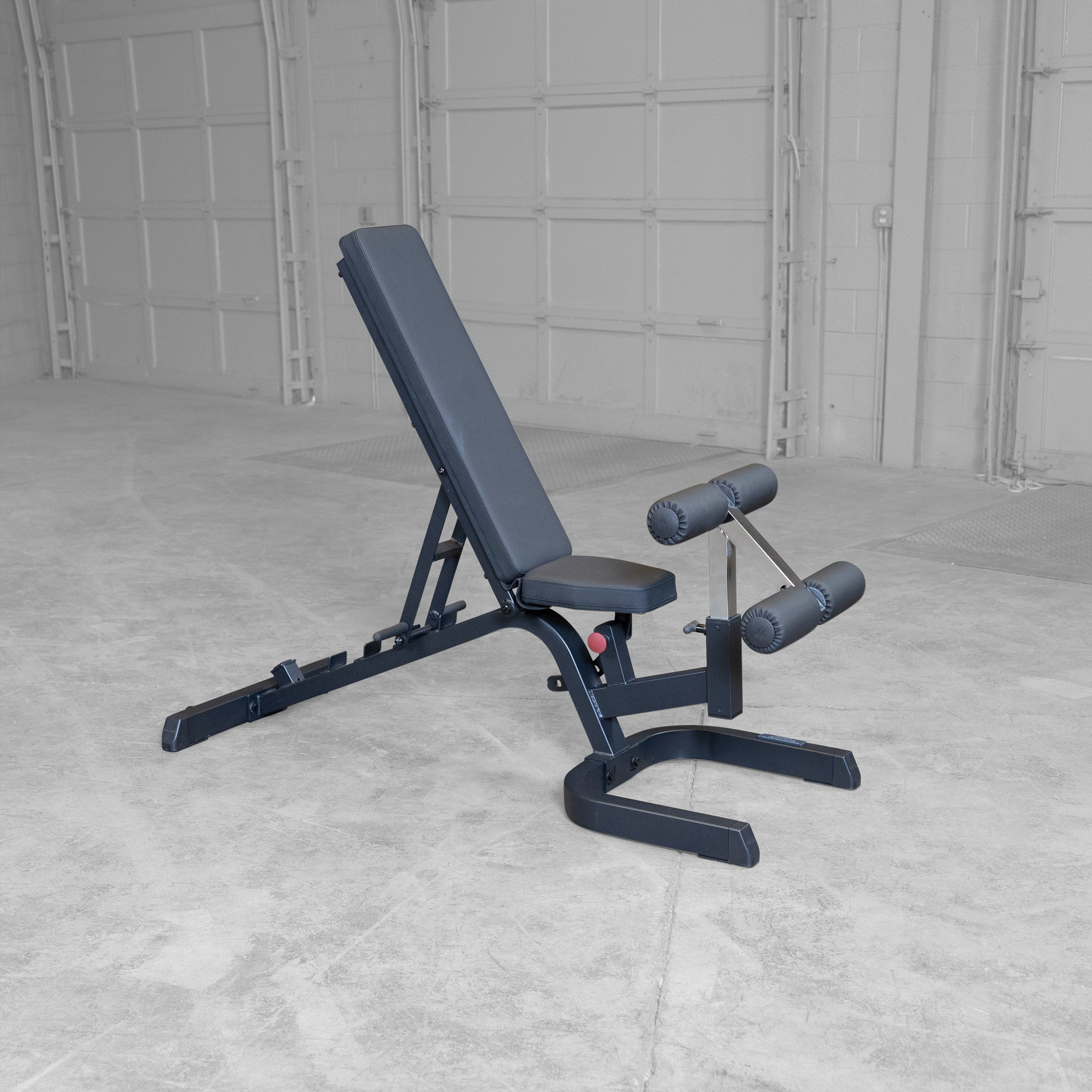 Body-Solid GFID71B Heavy Duty Flat Incline Decline Bench shown in the upright position with integrated leg hold-down attachment and commercial-grade steel frame