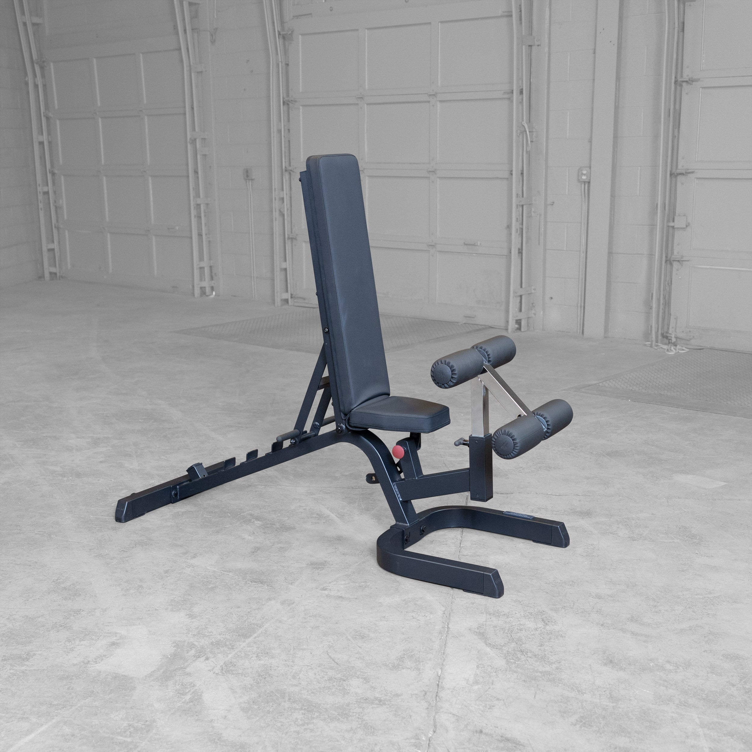 Body-Solid GFID71B Heavy Duty Flat Incline Decline Bench shown in the vertical position with integrated leg hold-down attachment and commercial-grade steel frame