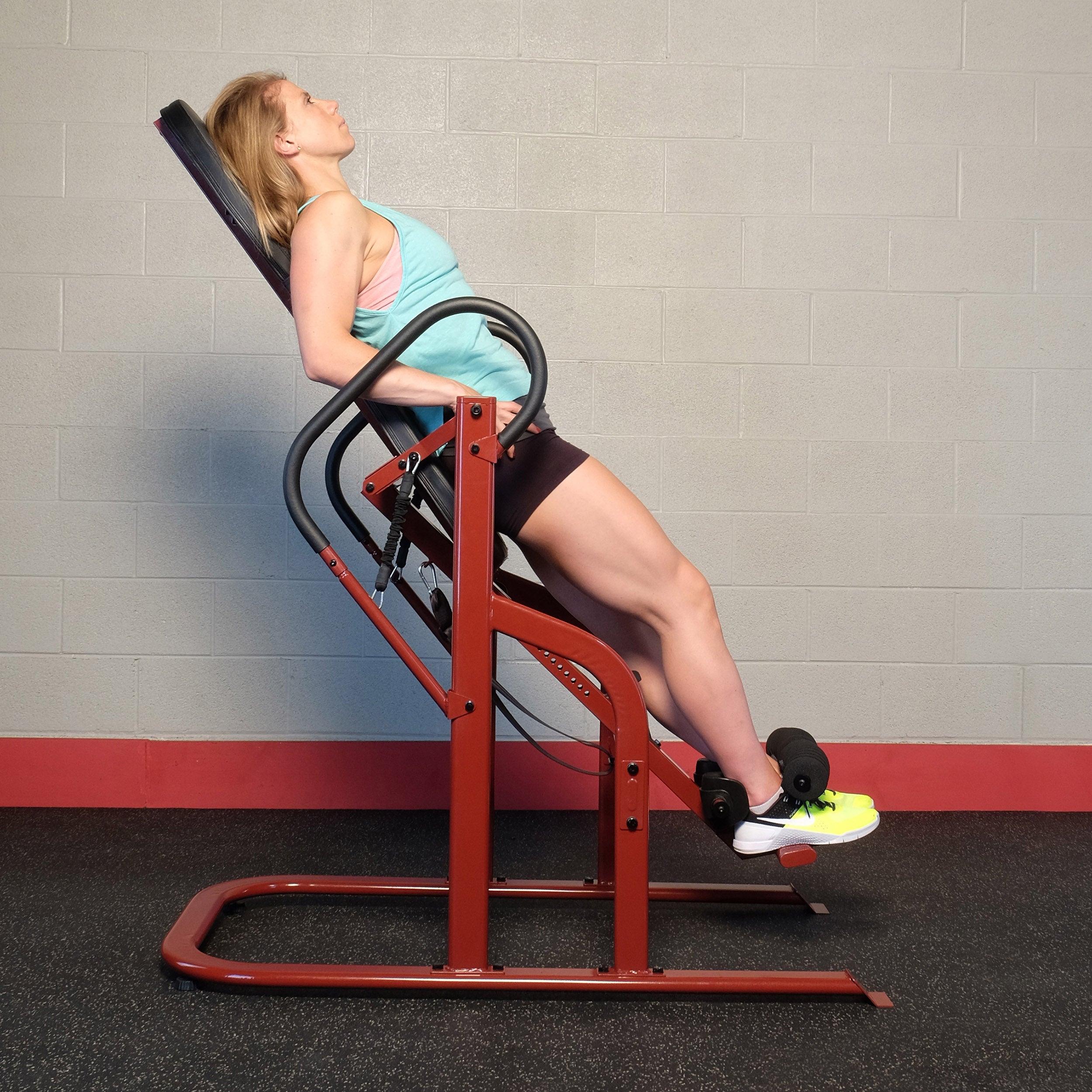 Woman using the Body-Solid GINV50 Inversion Table in a partial inversion position