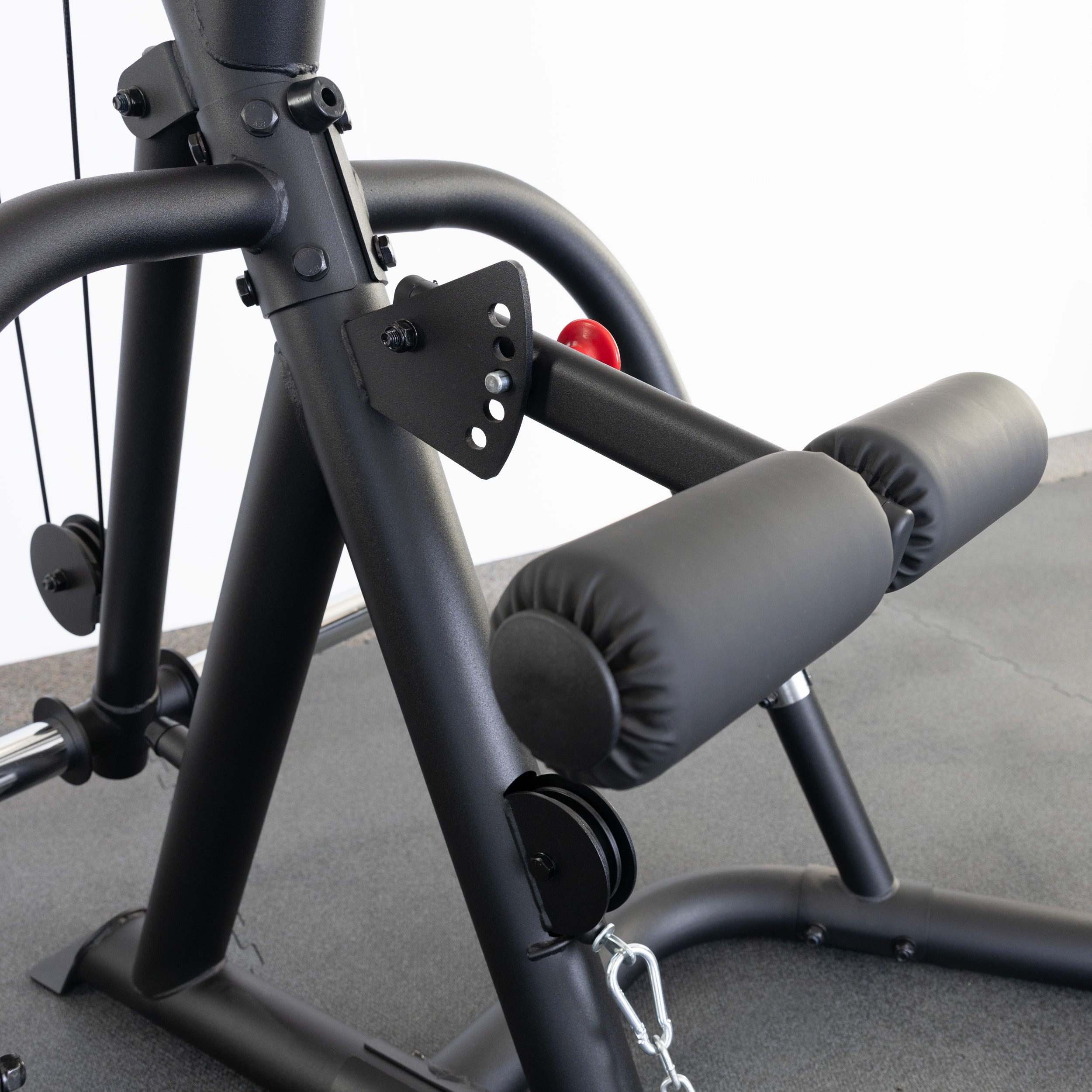 Close-up of the Body-Solid GLGS100B Corner Leverage Gym adjustable leg hold-down pads